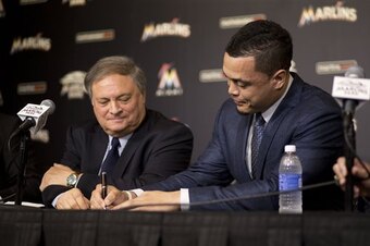 Giancarlo Stanton, signing his name to the largest contract in MLB history.