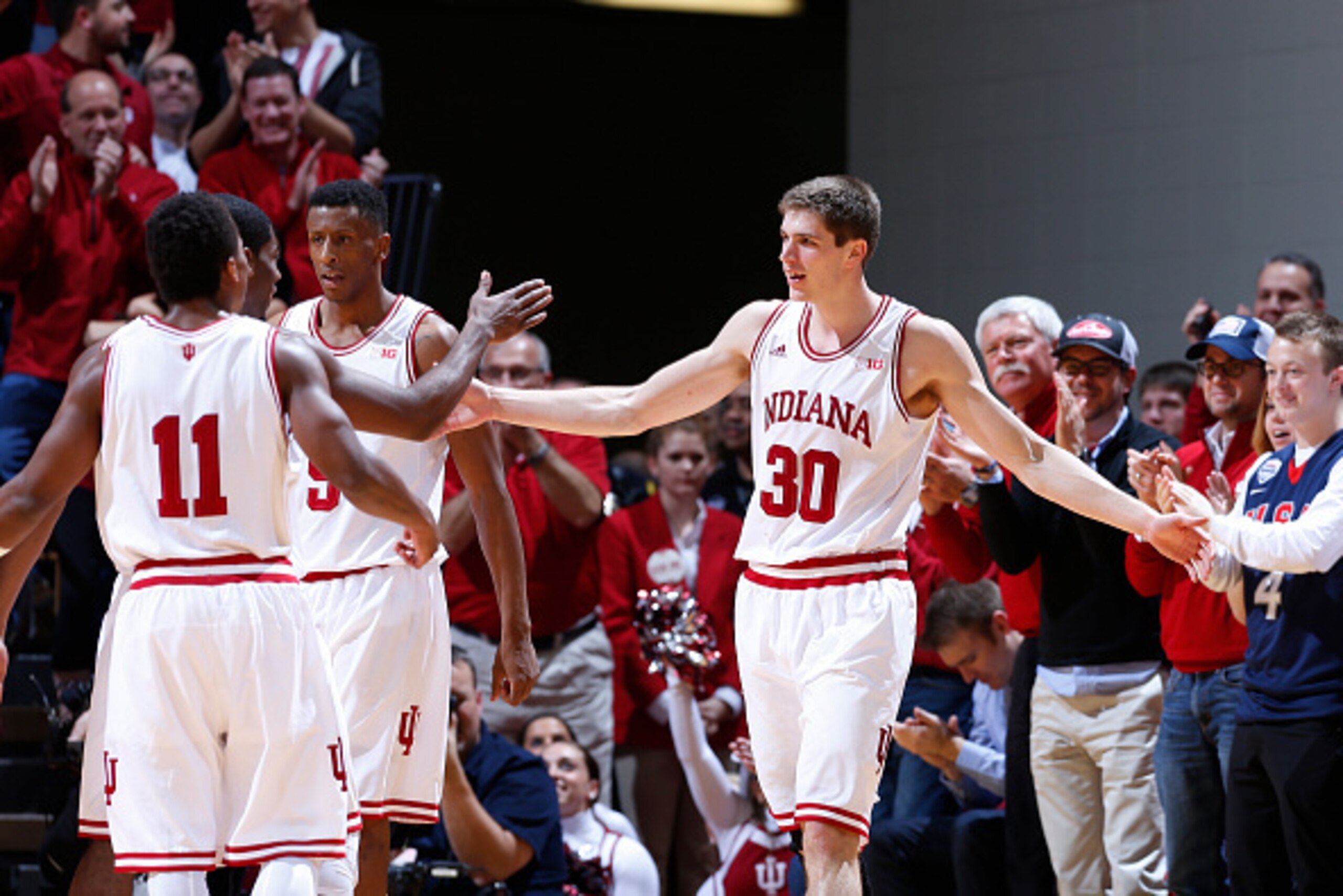 BLOOMINGTON, IN - JANUARY 22: Collin Hartman #30 of the Indiana Hoosiers celebrates with teammates after a made basket against the Maryland Terrapins during the game at Assembly Hall on January 22, 2015 in Bloomington, Indiana. The Hoosiers defeated the T