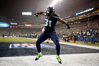 SEATTLE, WA - JANUARY 10:  Kam Chancellor #31 of the Seattle Seahawks celebrates after scoring a 90 yard touchdown off of an interception in the fourth quarter thrown by Cam Newton #1 of the Carolina Panthers iduring the 2015 NFC Divisional Playoff game a