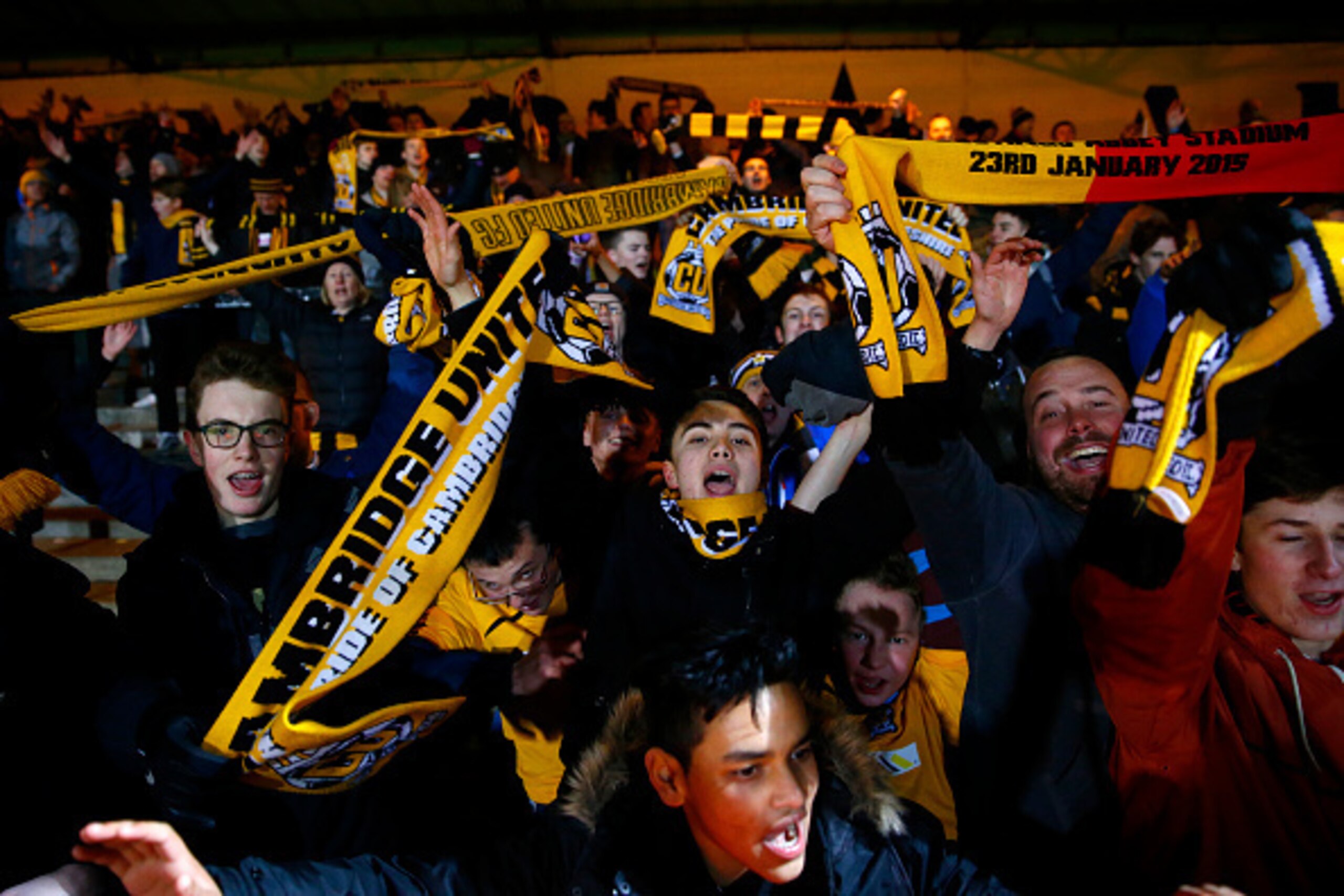 CAMBRIDGE, ENGLAND - JANUARY 23:  Cambridge United fans celebrate after the FA Cup Fourth Round match between Cambridge United and Manchester United at The R Costings Abbey Stadium on January 23, 2015 in Cambridge, England.  (Photo by Julian Finney/Getty 