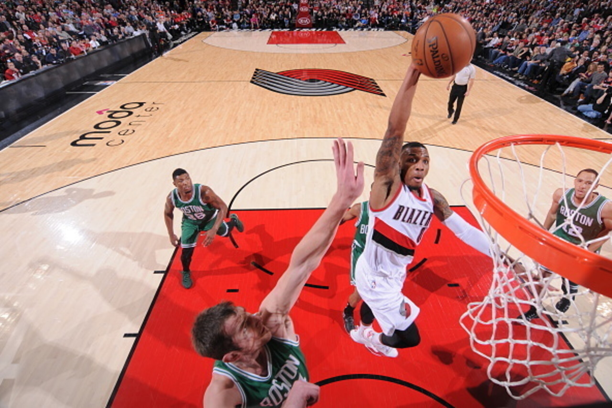 PORTLAND, OR - JANUARY 22:  Damian Lillard #0 of the Portland Trail Blazers goes up for a dunk against the Boston Celtics during the game on January 22, 2015 at the Moda Center in Portland, Oregon. NOTE TO USER: User expressly acknowledges and agrees that