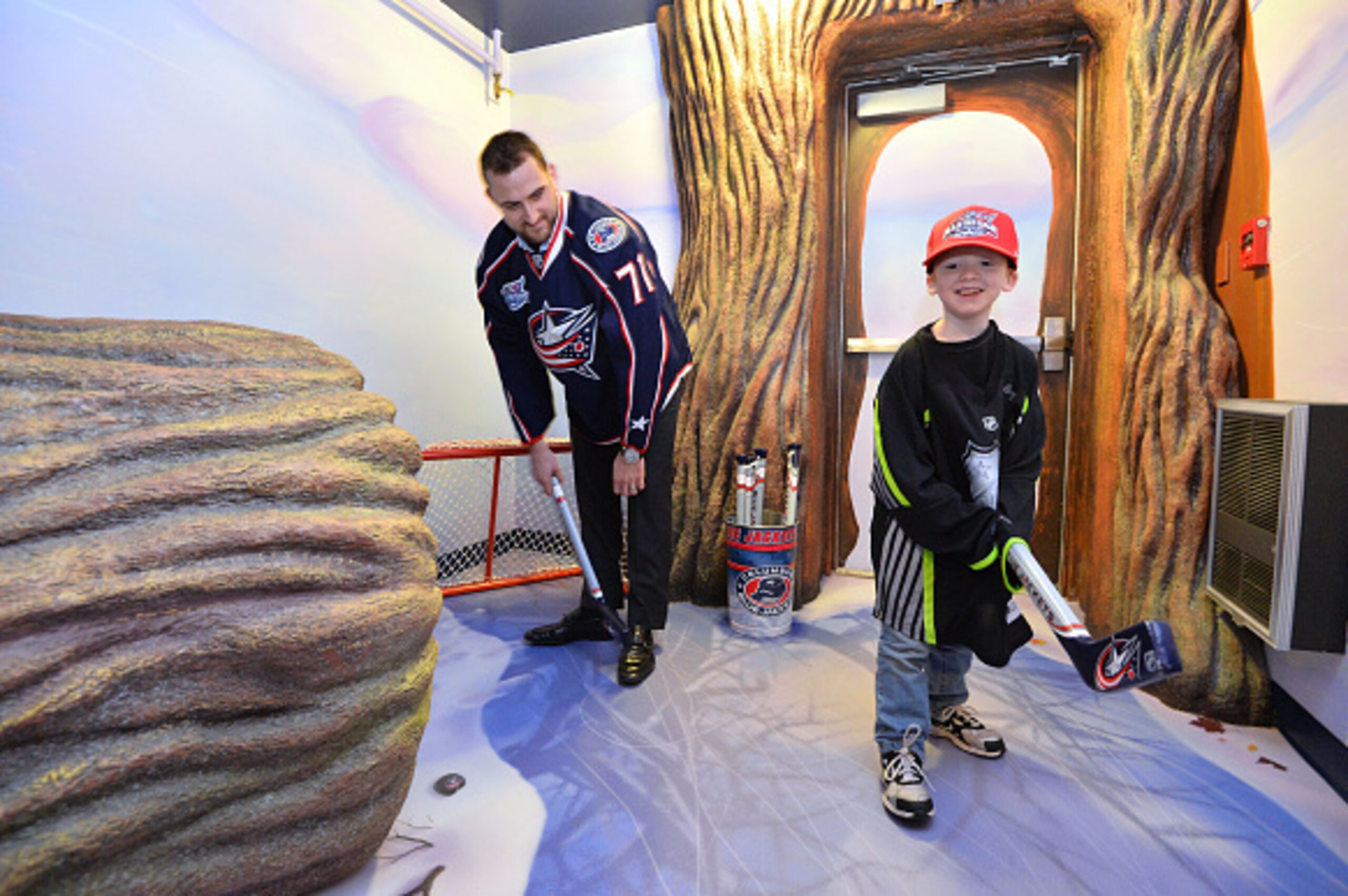 COLUMBUS, OH - JANUARY 23:  Nick Foligno #71 of the Columbus Blue Jackets and a young resident of the Ronald McDonald House of Central Ohio play hockey at the Legacy Treehouse Unveiling at Ronald McDonald House as part of the 2015 NHL All-Star Game weeken
