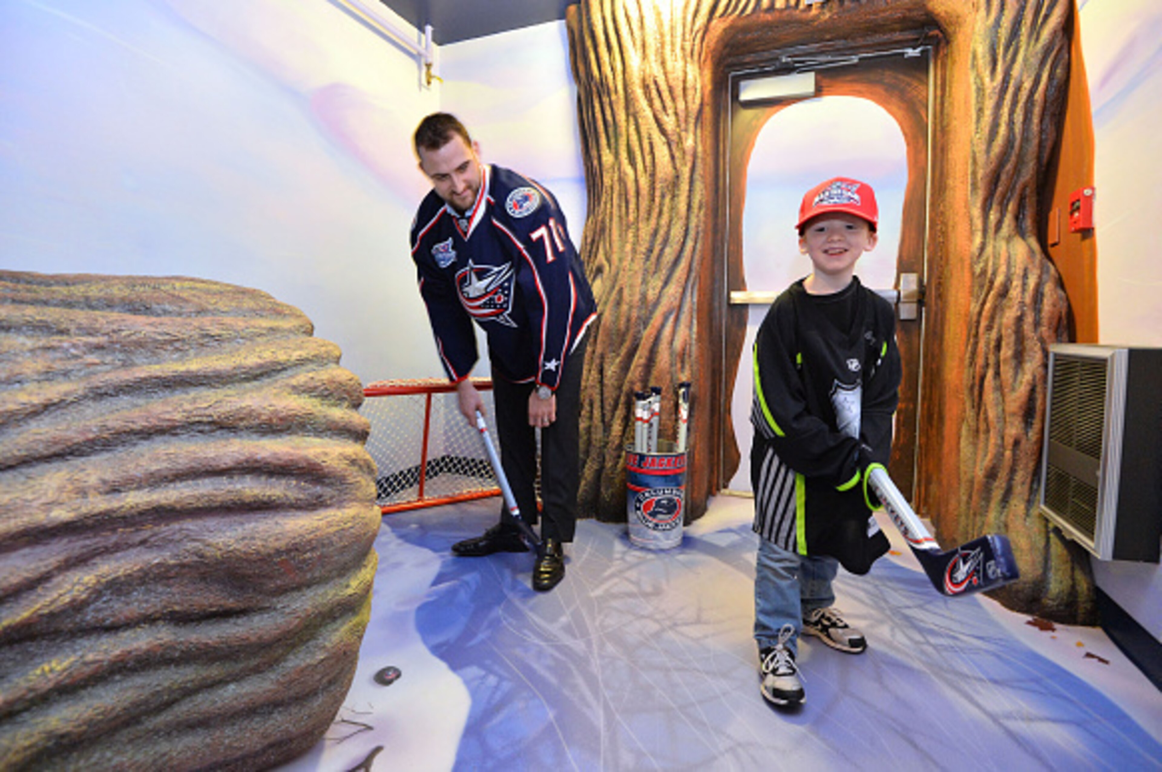 COLUMBUS, OH - JANUARY 23:  Nick Foligno #71 of the Columbus Blue Jackets and a young resident of the Ronald McDonald House of Central Ohio play hockey at the Legacy Treehouse Unveiling at Ronald McDonald House as part of the 2015 NHL All-Star Game weeken