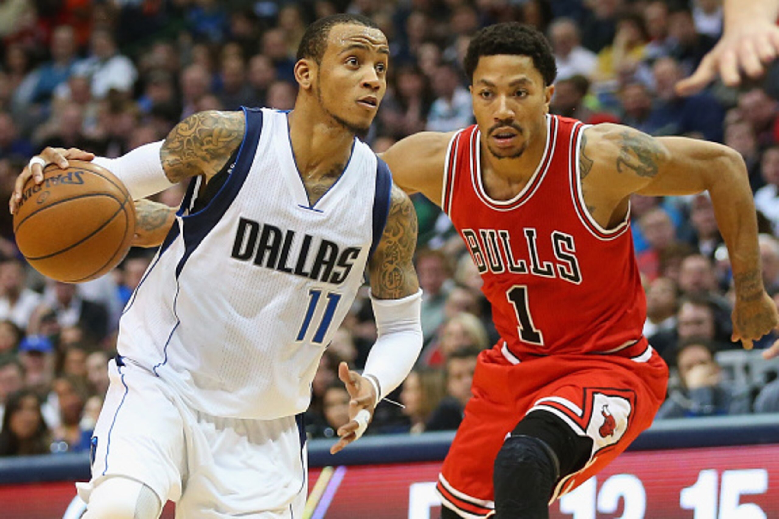 DALLAS, TX - JANUARY 23:  Monta Ellis #11 of the Dallas Mavericks dribbles the ball against Derrick Rose #1 of the Chicago Bulls at American Airlines Center on January 23, 2015 in Dallas, Texas.  NOTE TO USER: User expressly acknowledges and agrees that, 