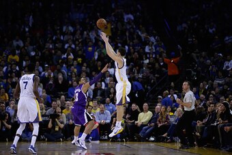 OAKLAND, CA - JANUARY 23:  Klay Thompson #11 of the Golden State Warriors shoots over Ray McCallum #3 of the Sacramento Kings in the third quarter at ORACLE Arena on January 23, 2015 in Oakland, California. Thompson scored 37 points in the third quarter t
