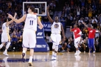 Jan 21, 2015; Oakland, CA, USA; Golden State Warriors center Andrew Bogut (12), guard Klay Thompson (11), and forward Draymond Green (23) celebrate after the Warriors' score against the Houston Rockets during the third quarter at Oracle Arena. The Warrior