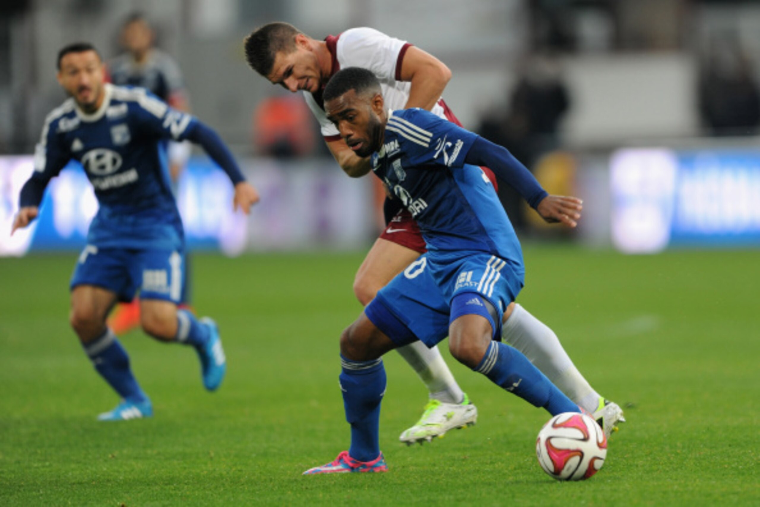 METZ, FRANCE - AUGUST 31:  Alexandre Lacazette of Lyon and Jeremy Chopilin of Metz compete for the ball during the French Ligue 1 match between FC Metz and Olympique Lyonnais at Stade Saint-Symphorien on August 31, 2014 in Metz, France.  (Photo by Kaz Pho