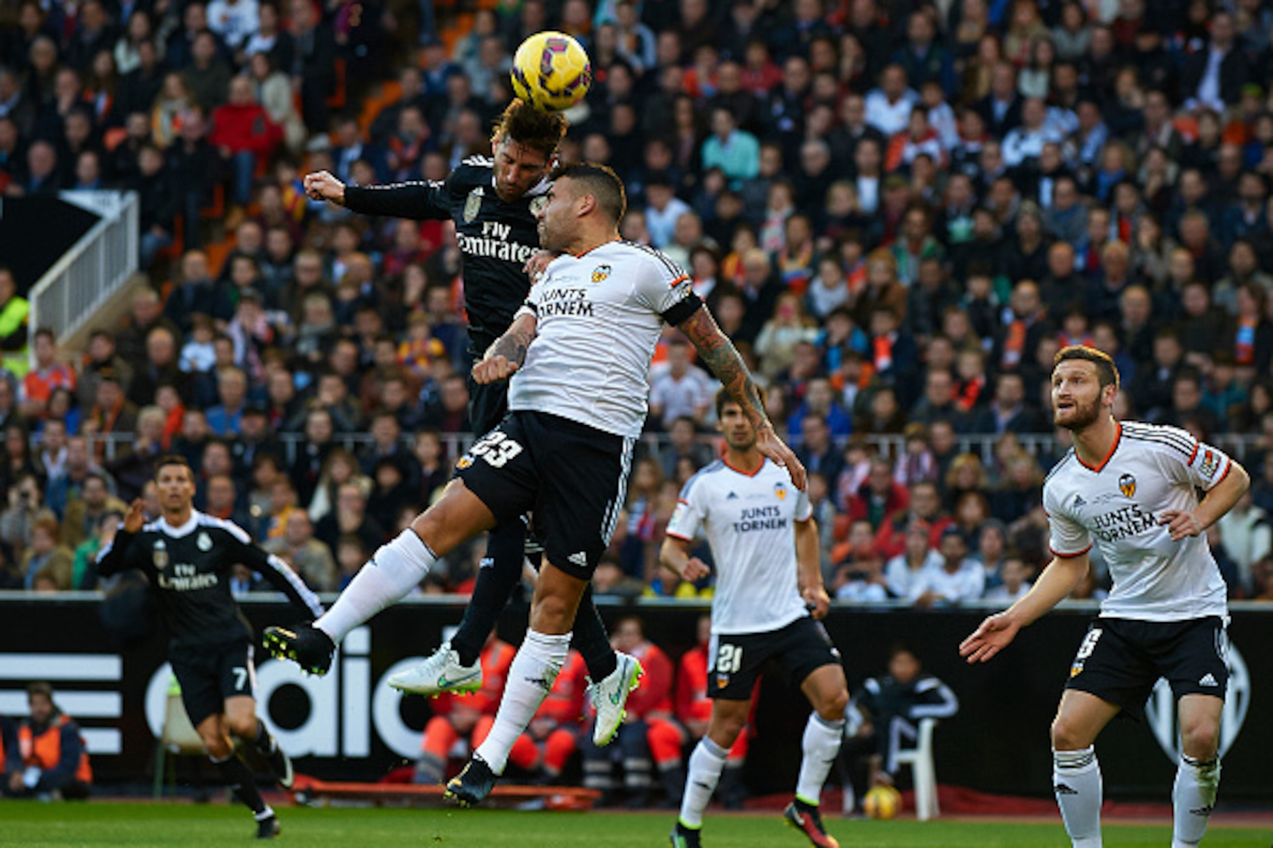 VALENCIA, SPAIN - JANUARY 04:  Nicolas Otamendi of Valencia competes for the ball with Sergio Ramos (L) of Real Madrid during the La Liga match between Valencia CF and Real Madrid CF at Estadi de Mestalla on January 4, 2015 in Valencia, Spain.  (Photo by 