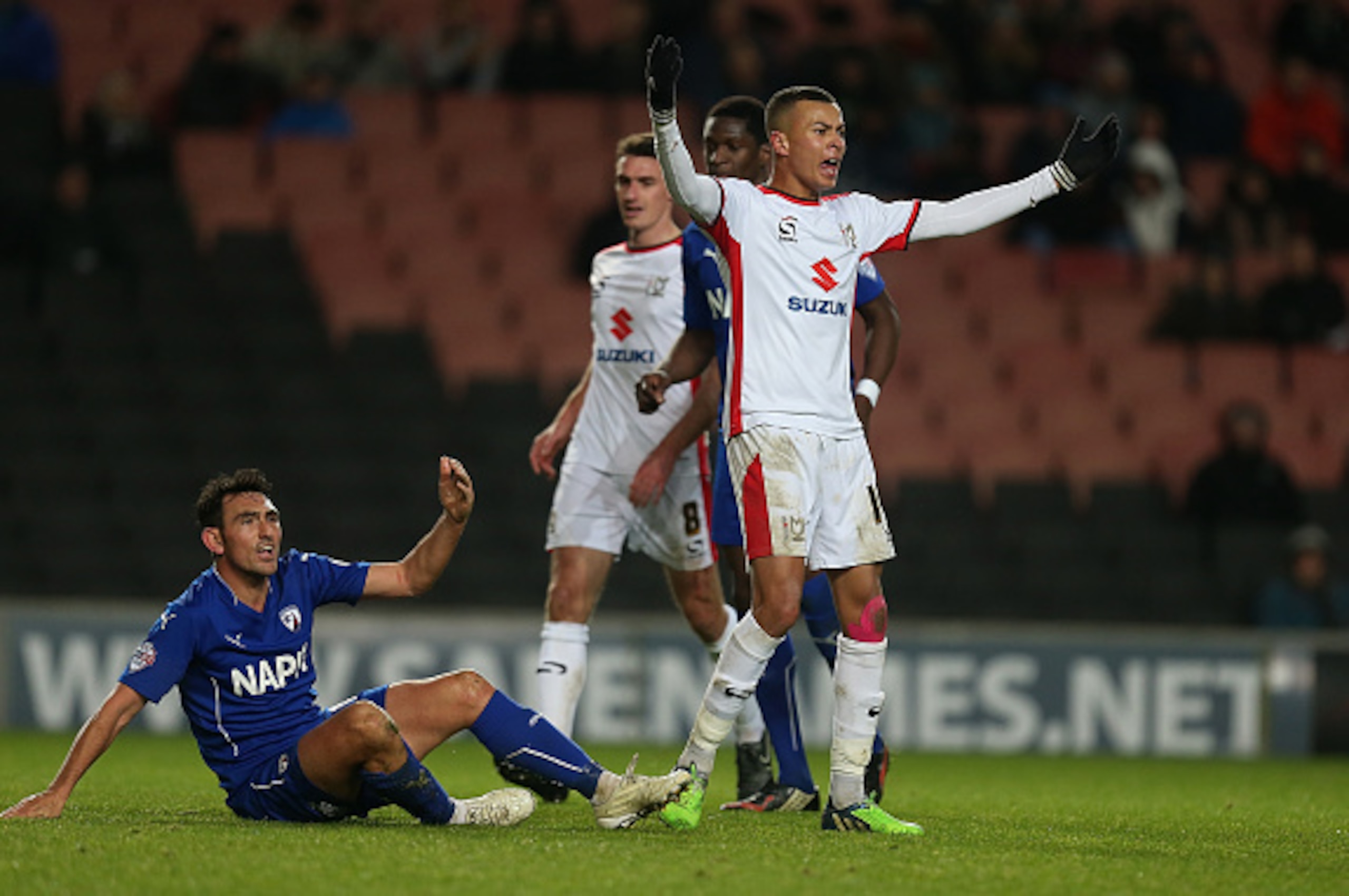 MILTON KEYNES, ENGLAND - DECEMBER 06: Dele Alli of MK Dons remonstrates after committing a foul on Gary Roberts (l) of Chesterfield during the FA Cup Second Round match between MK Dons and Chesterfield at Stadium mk on December 6, 2014 in Milton Keynes, E