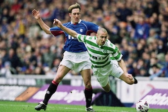 GLASGOW - MARCH 10:  Henrik Larsson of Celtic is sent flying by the challenge of Fernando Ricksen of Rangers during the Scottish Premier Division match held on March 10, 2002 at Ibrox, in Glasgow, Scotland. The match ended in a 1-1 draw. (Photo by Alex Li