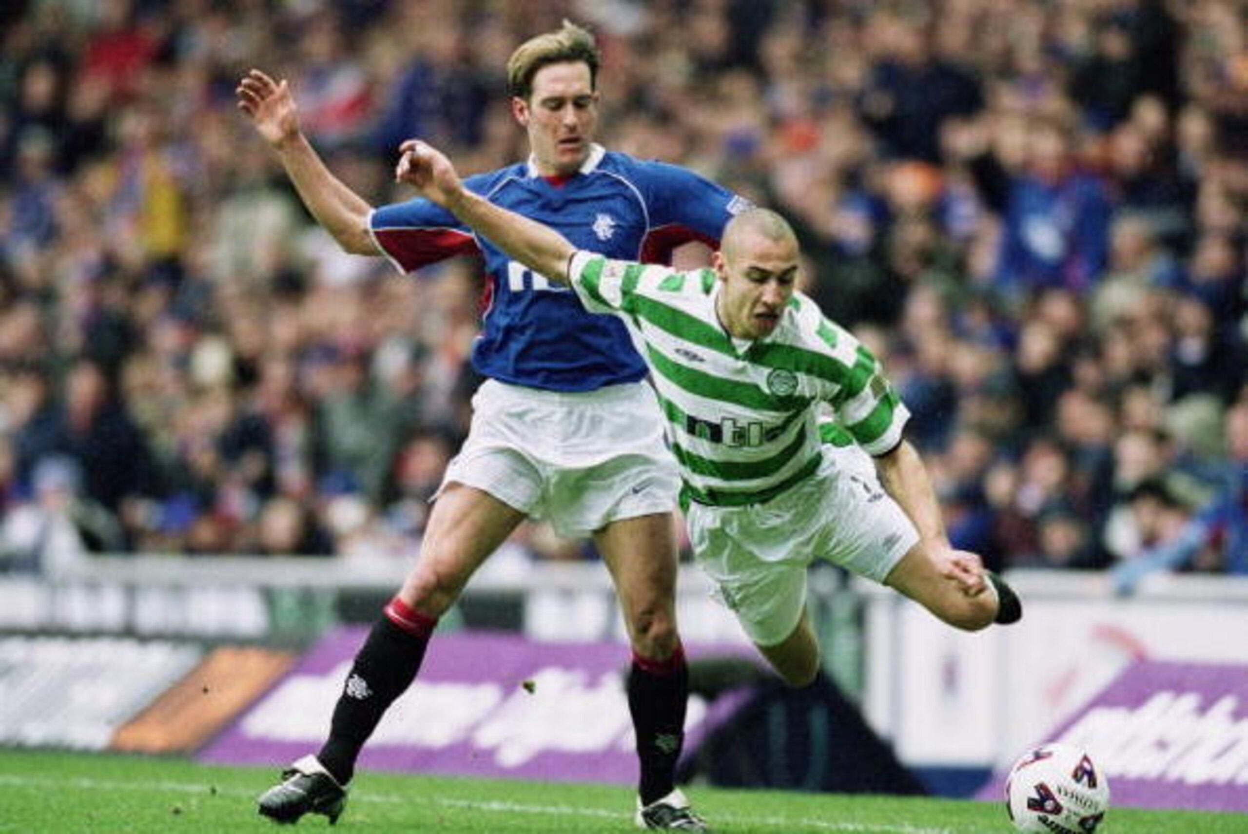 GLASGOW - MARCH 10: Henrik Larsson of Celtic is sent flying by the challenge of Fernando Ricksen of Rangers during the Scottish Premier Division match held on March 10, 2002 at Ibrox, in Glasgow, Scotland. The match ended in a 1-1 draw. (Photo by Alex Li GLASGOW - MARCH 10: Henrik Larsson of Celtic is sent flying by the challenge of Fernando Ricksen of Rangers during the Scottish Premier Division match held on March 10, 2002 at Ibrox, in Glasgow, Scotland. The match ended in a 1-1 draw. (Photo by Alex Li