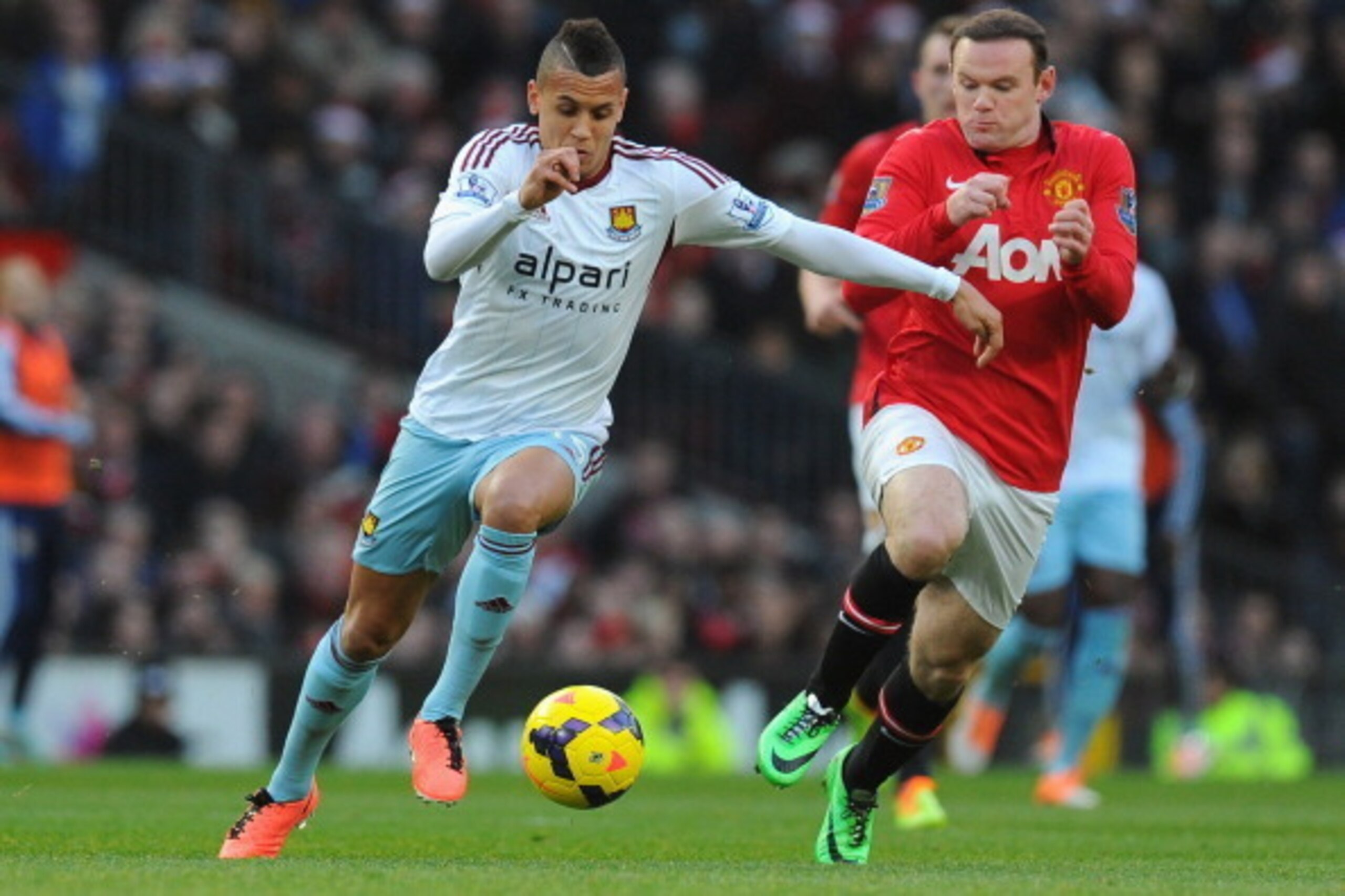 MANCHESTER, ENGLAND - DECEMBER 21:  Ravel Morrison of West Ham United competes with Wayne Rooney of Manchester United during the Barclays Premier League match between Manchester United and West Ham United at Old Trafford on December 21, 2013 in Manchester