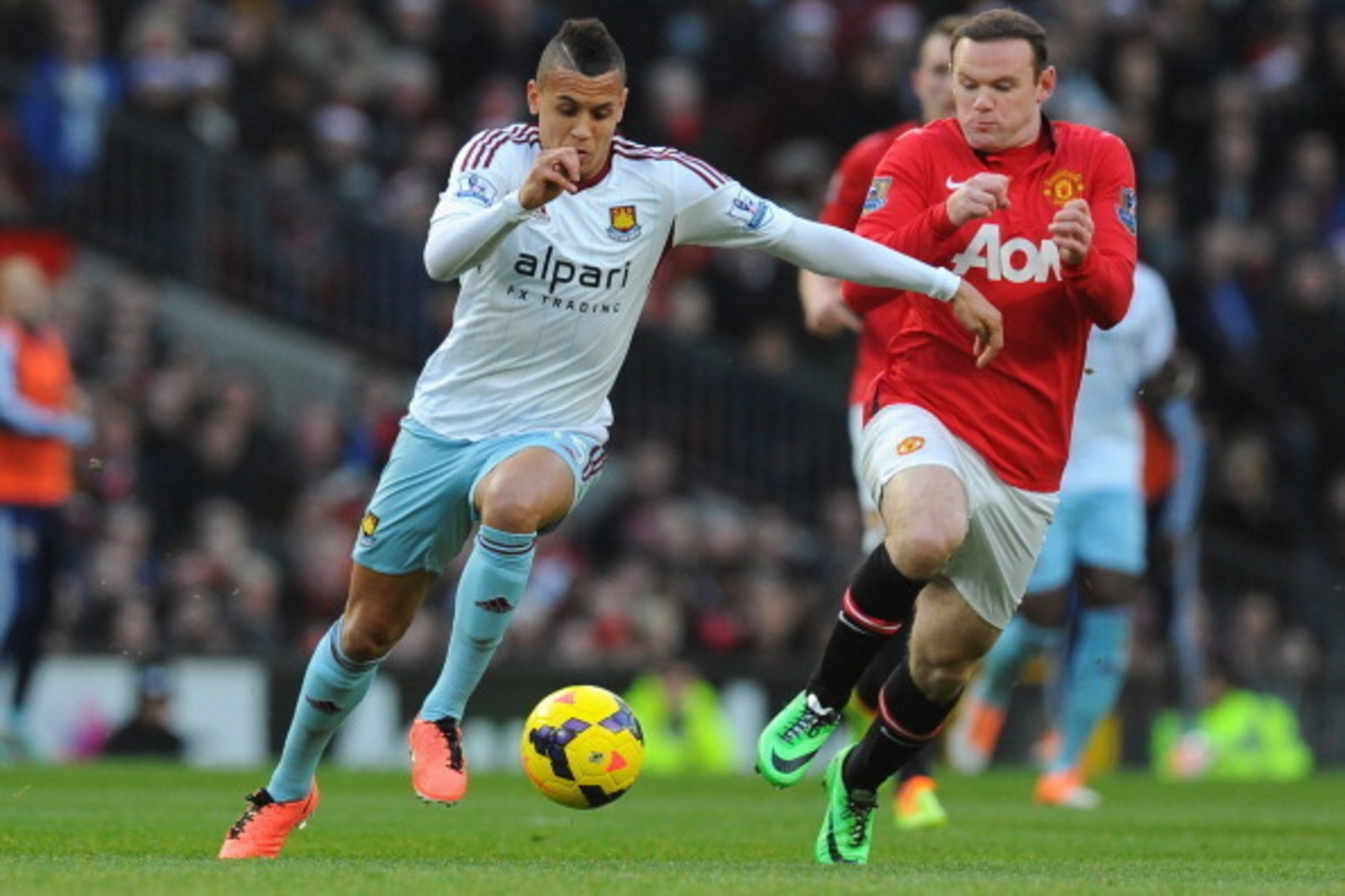 MANCHESTER, ENGLAND - DECEMBER 21:  Ravel Morrison of West Ham United competes with Wayne Rooney of Manchester United during the Barclays Premier League match between Manchester United and West Ham United at Old Trafford on December 21, 2013 in Manchester