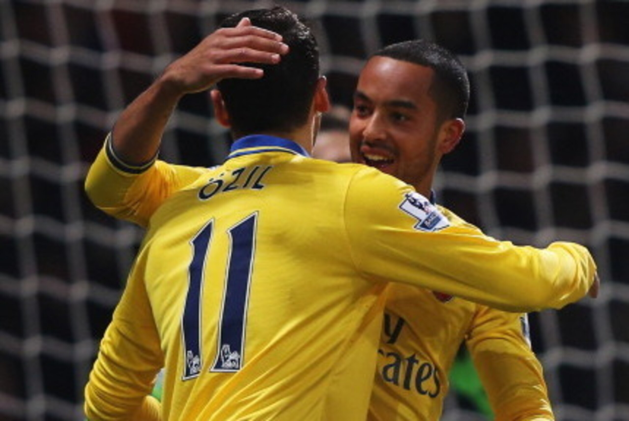 LONDON, ENGLAND - DECEMBER 26: Theo Walcott of Arsenal (R) celebrates with Mesut Oezil (11) as he scores their first goal during the Barclays Premier League match between West Ham United and Arsenal at Boleyn Ground on December 26, 2013 in London, Englan LONDON, ENGLAND - DECEMBER 26: Theo Walcott of Arsenal (R) celebrates with Mesut Oezil (11) as he scores their first goal during the Barclays Premier League match between West Ham United and Arsenal at Boleyn Ground on December 26, 2013 in London, Englan