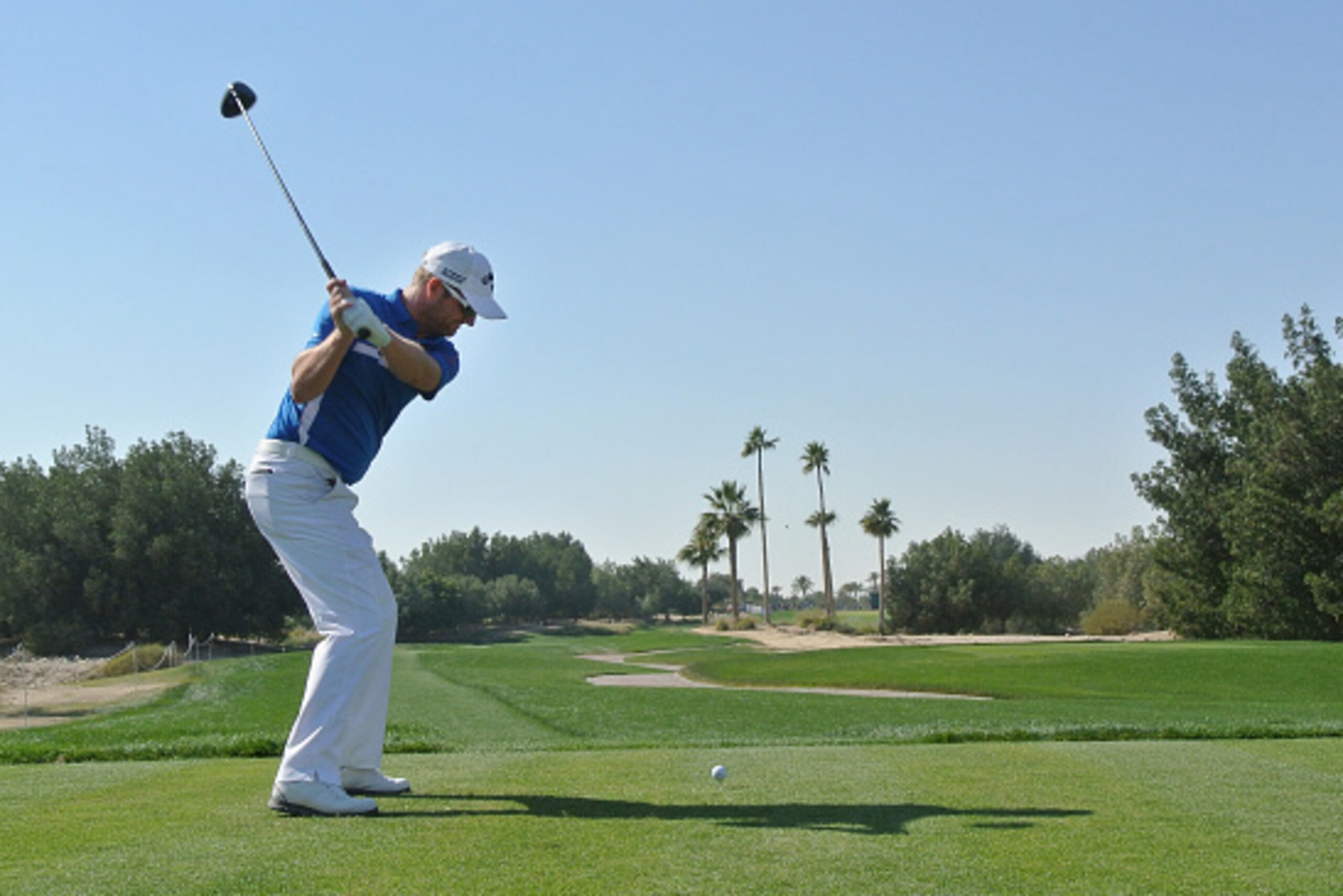 DOHA, QATAR - JANUARY 24:  Marc Warren of Scotland hits his tee-shot on the fifth hole during the final round of the Commercial Bank Qatar Masters at Doha Golf Club on January 24, 2015 in Doha, Qatar.  (Photo by Andrew Redington/Getty Images)