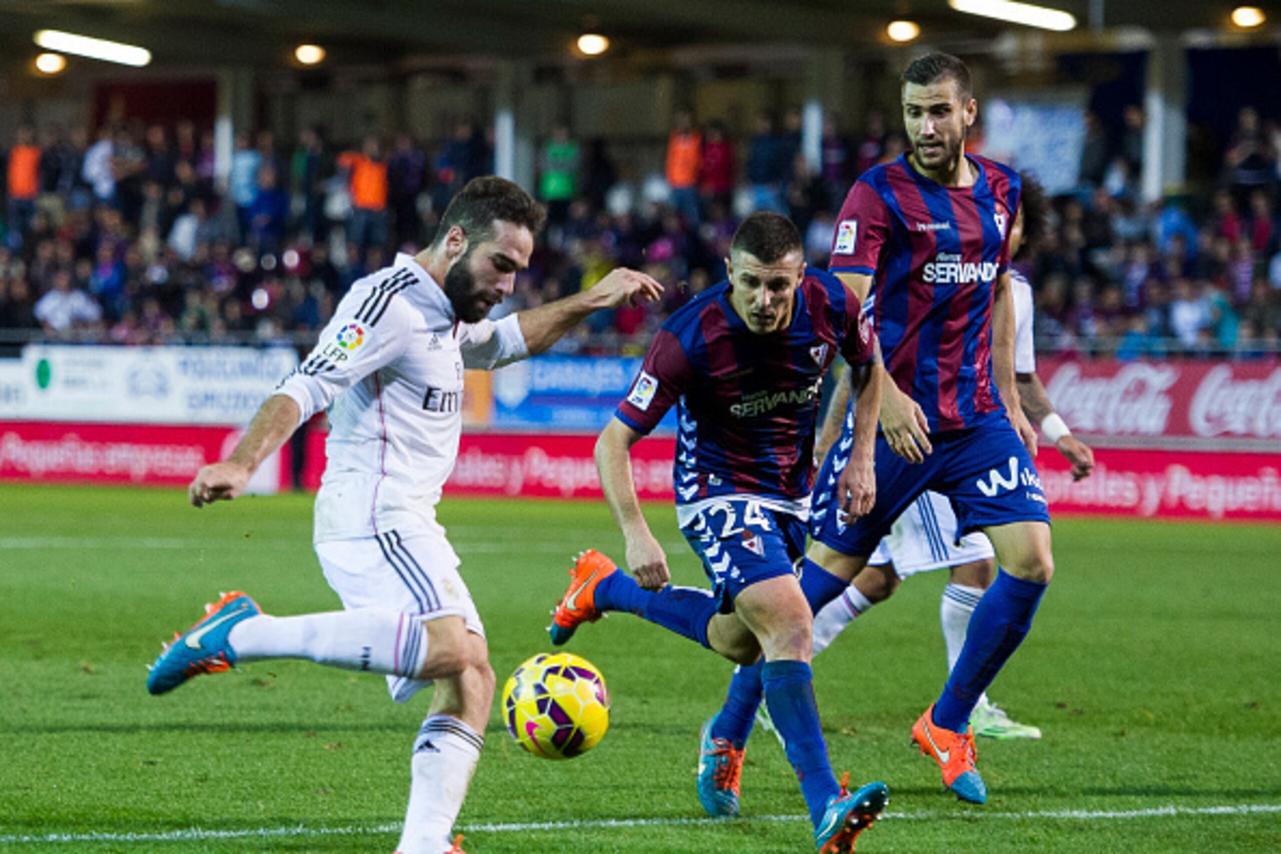 EIBAR, SPAIN - NOVEMBER 22: Daniel Carvajal of Real Madrid duels for the ball with Abraham MInero of SD Eibar during the La Liga match between SD Eibar and Real Madrid at Ipurua Municipal Stadium on November 22, 2014 in Eibar, Spain. (Photo by Juan Manuel EIBAR, SPAIN - NOVEMBER 22: Daniel Carvajal of Real Madrid duels for the ball with Abraham MInero of SD Eibar during the La Liga match between SD Eibar and Real Madrid at Ipurua Municipal Stadium on November 22, 2014 in Eibar, Spain. (Photo by Juan Manuel