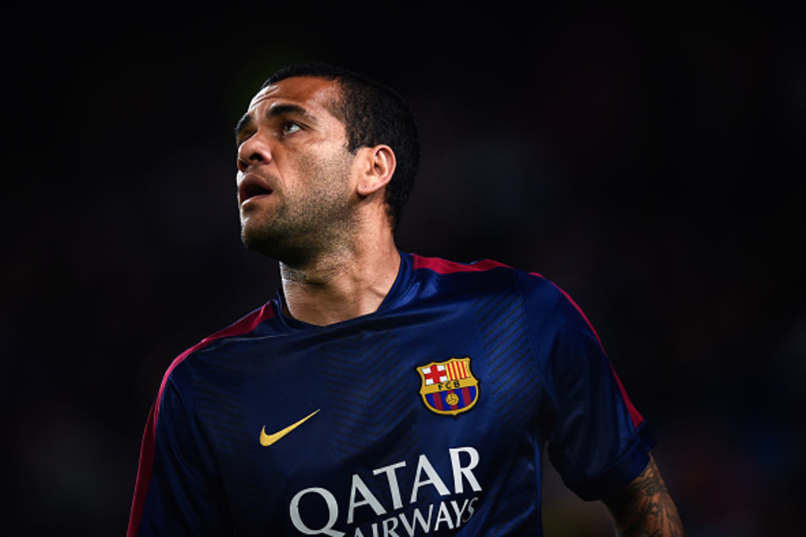 BARCELONA, SPAIN - NOVEMBER 22:  Dani Alves of FC Barcelona looks on  during the warm-up prior to the La Liga match between FC Barcelona and Sevilla FC at Camp Nou on November 22, 2014 in Barcelona, Spain. Lionel Messi beat the  number of goal in the Span