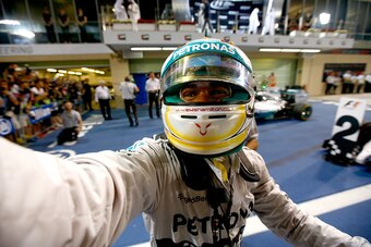 ABU DHABI, UNITED ARAB EMIRATES - NOVEMBER 23:  Lewis Hamilton of Great Britain and Mercedes GP celebrates in Parc Ferme after winning the World Championship and the Abu Dhabi Formula One Grand Prix at Yas Marina Circuit on November 23, 2014 in Abu Dhabi,