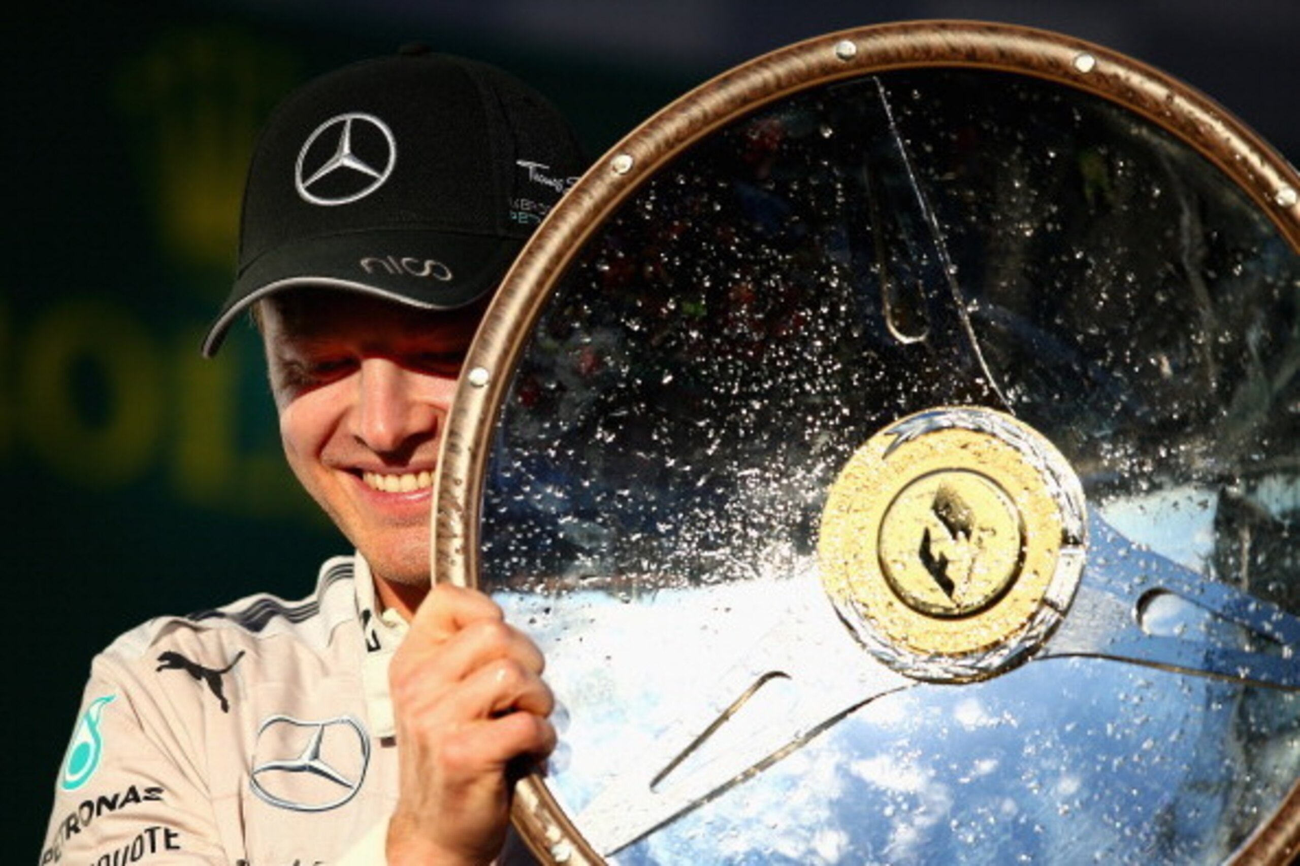 MELBOURNE, AUSTRALIA - MARCH 16:  Nico Rosberg of Germany and Mercedes GP celebrates on the podium after winning the Australian Formula One Grand Prix at Albert Park on March 16, 2014 in Melbourne, Australia.  (Photo by Clive Mason/Getty Images)