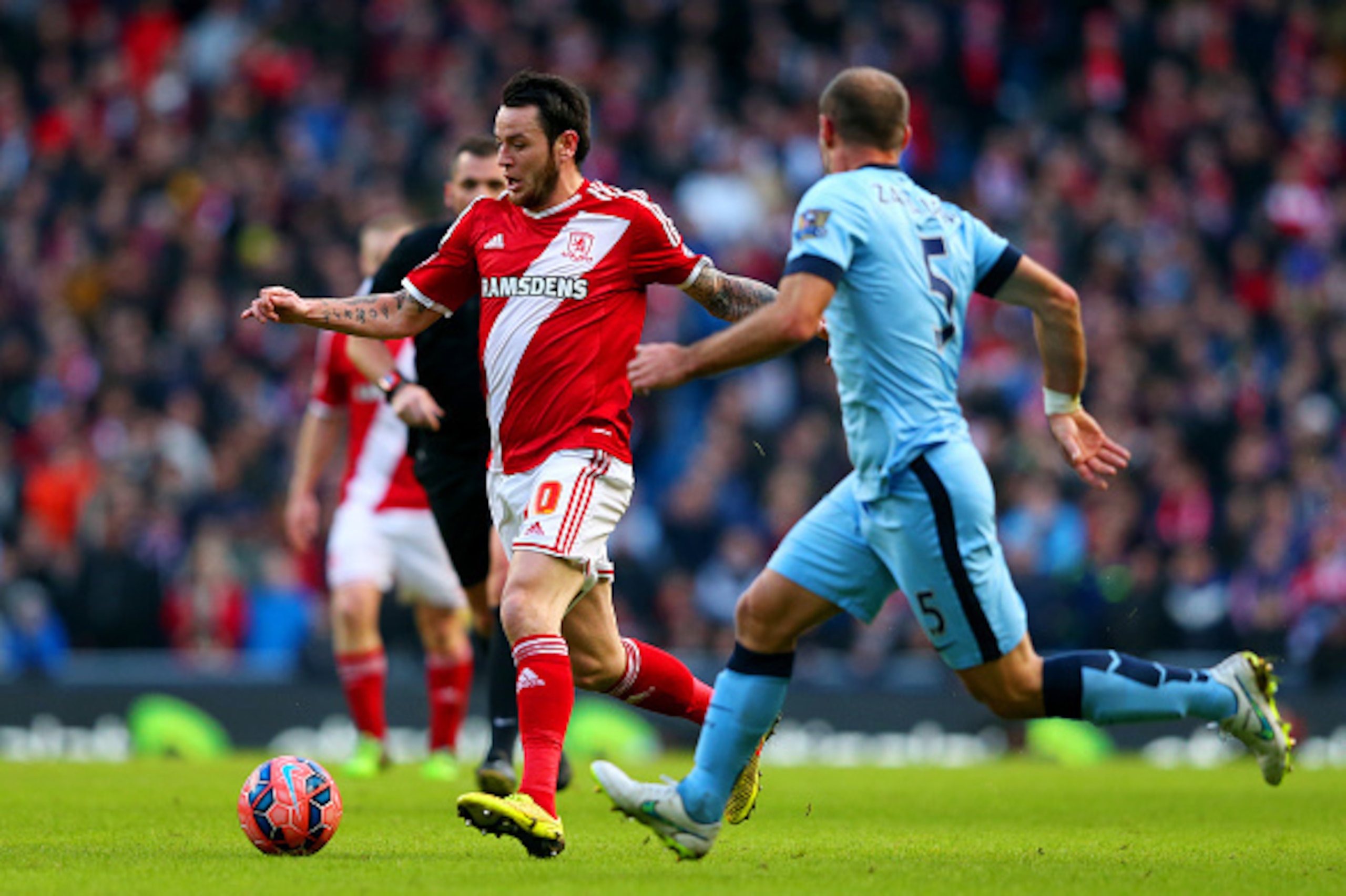 MANCHESTER, ENGLAND - JANUARY 24:  Lee Tomlin of Middlesbrough runs with the ball under pressure from Pablo Zabaleta of Manchester City during the FA Cup Fourth Round match between Manchester City and Middlesbrough at Etihad Stadium on January 24, 2015 in