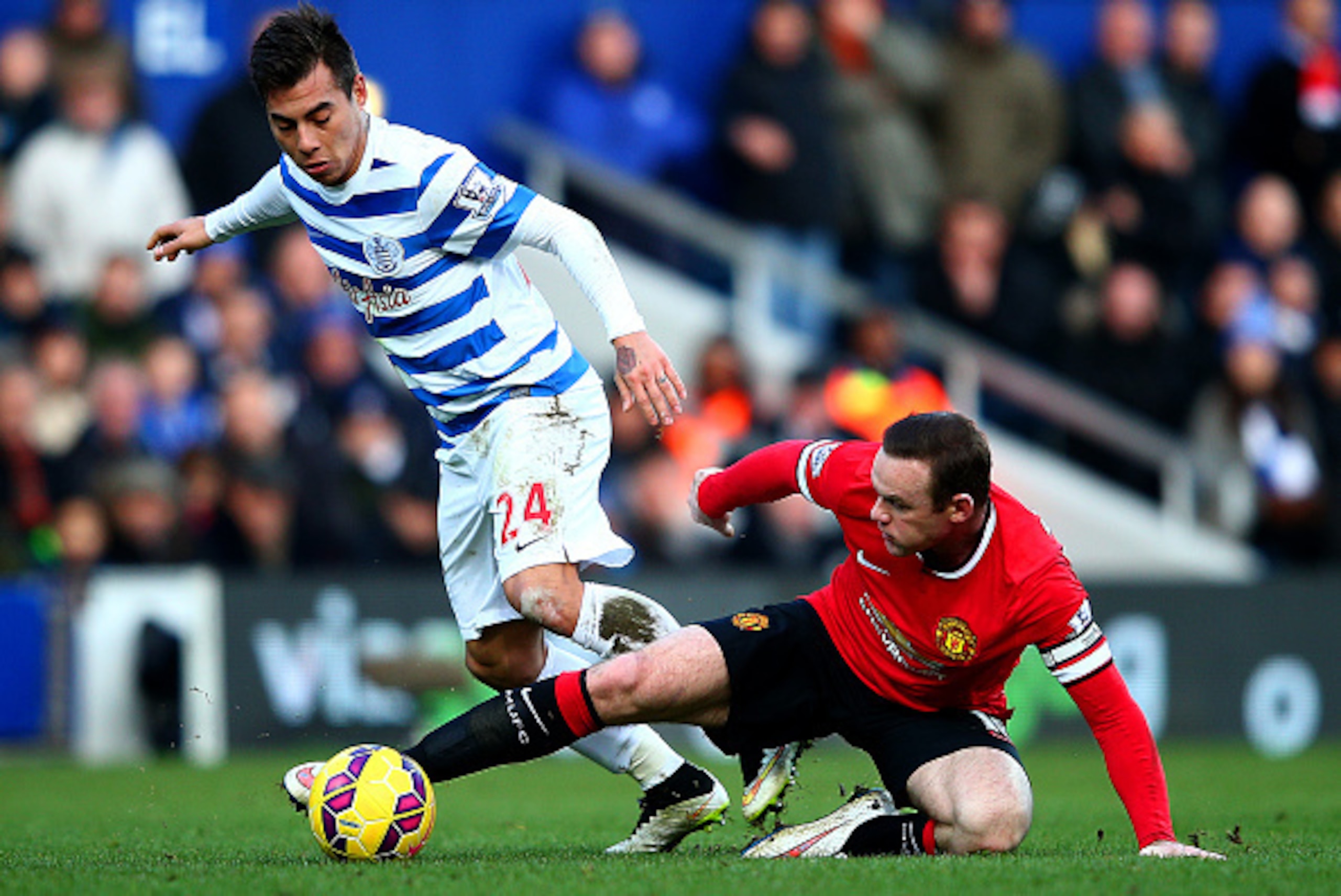 LONDON, ENGLAND - JANUARY 17: Wayne Rooney of Manchester United battles for the ball with Eduardo Vargas of QPR during the Barclays Premier League match between Queens Park Rangers and Manchester United at Loftus Road on January 17, 2015 in London, Engla LONDON, ENGLAND - JANUARY 17: Wayne Rooney of Manchester United battles for the ball with Eduardo Vargas of QPR during the Barclays Premier League match between Queens Park Rangers and Manchester United at Loftus Road on January 17, 2015 in London, Engla