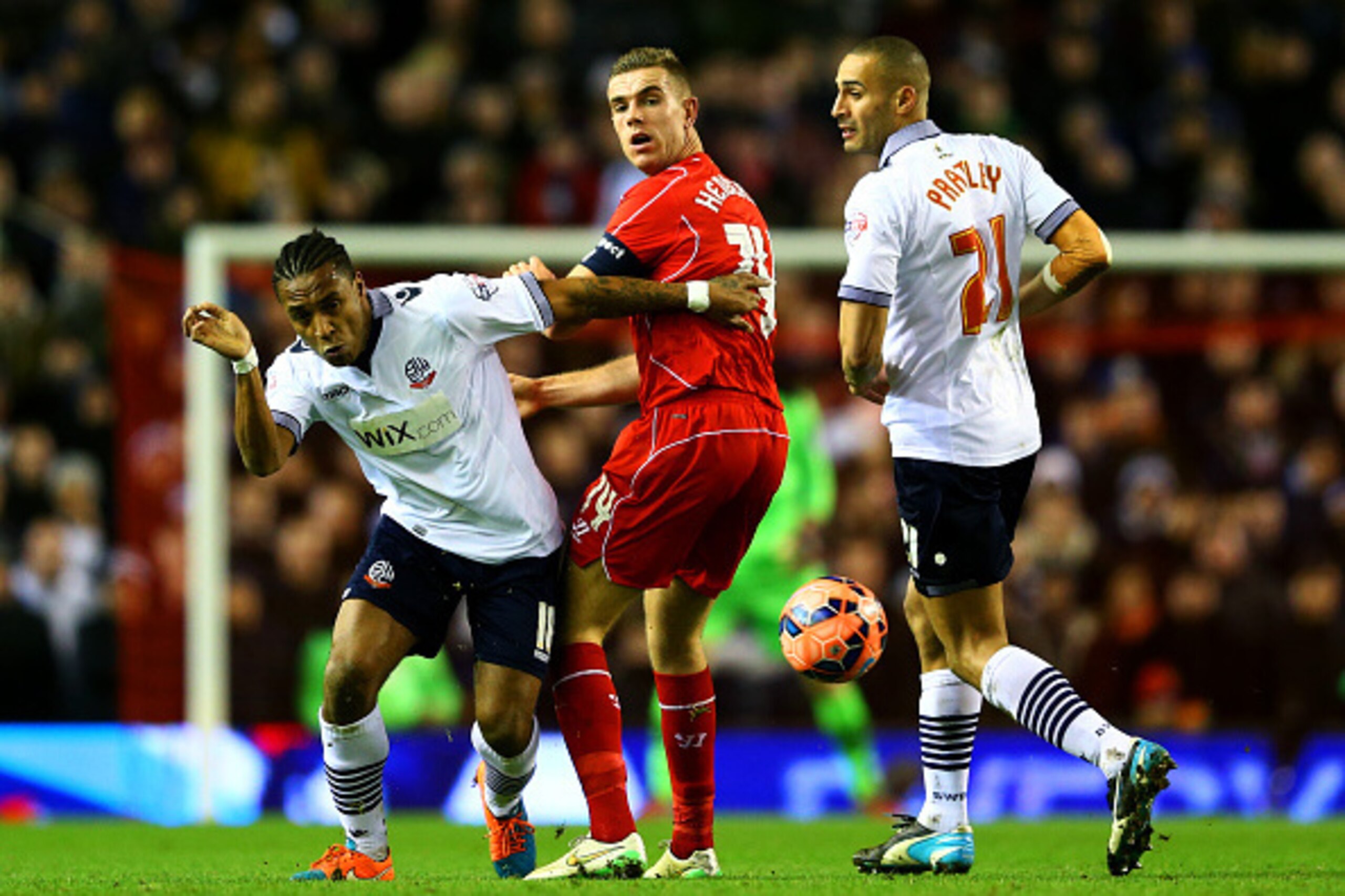 LIVERPOOL, ENGLAND - JANUARY 24:  Jordan Henderson of Liverpool battles for the ball with Neil Danns and Darren Pratley of Bolton Wanderers during the FA Cup Fourth Round match between Liverpool and Bolton Wanderers at Anfield on January 24, 2015 in Liver