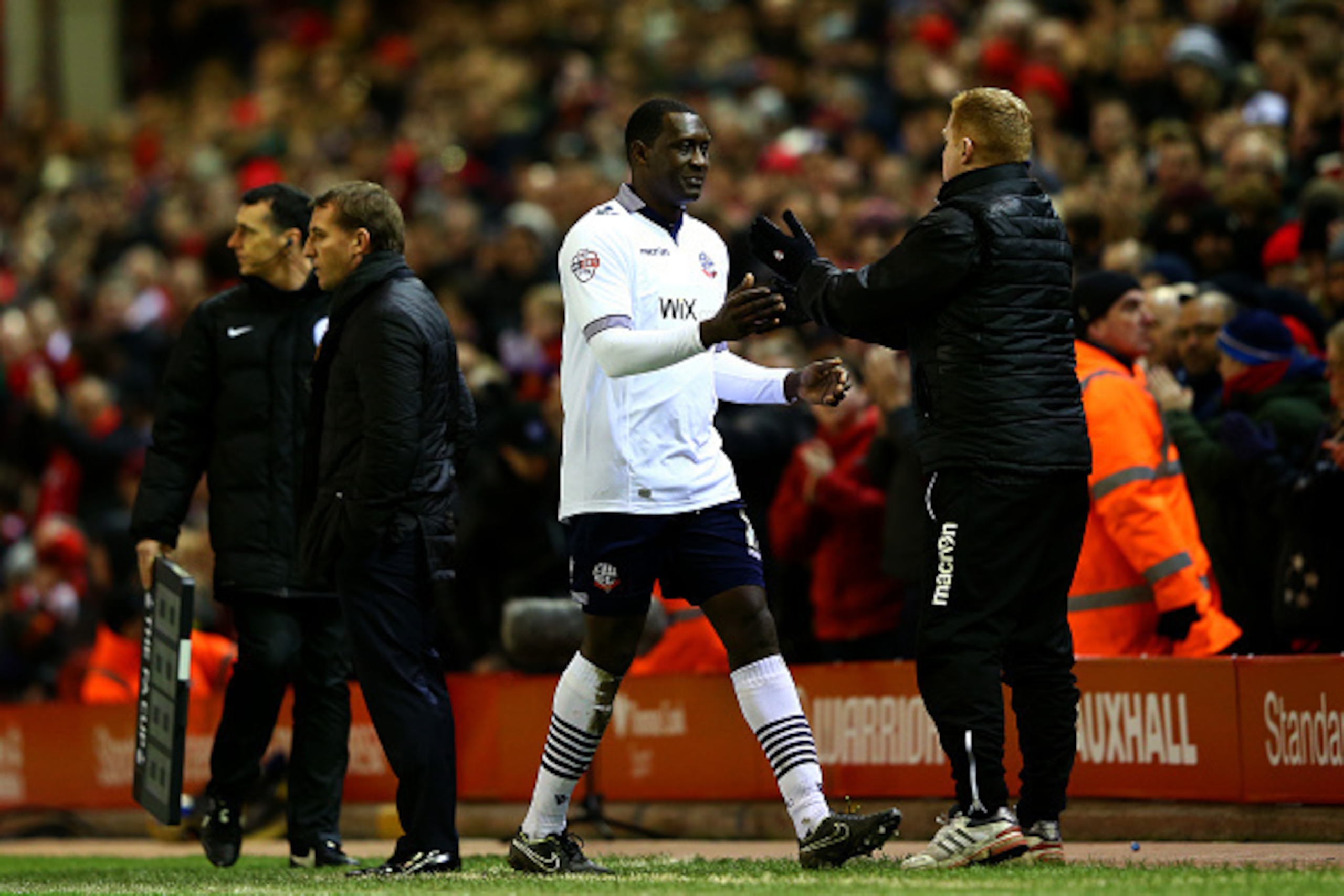 LIVERPOOL, ENGLAND - JANUARY 24:  Emile Heskey of Bolton Wanderers shakes hands with Neil Lennon, manager of Bolton Wanderers as he is substituted during the FA Cup Fourth Round match between Liverpool and Bolton Wanderers at Anfield on January 24, 2015 i