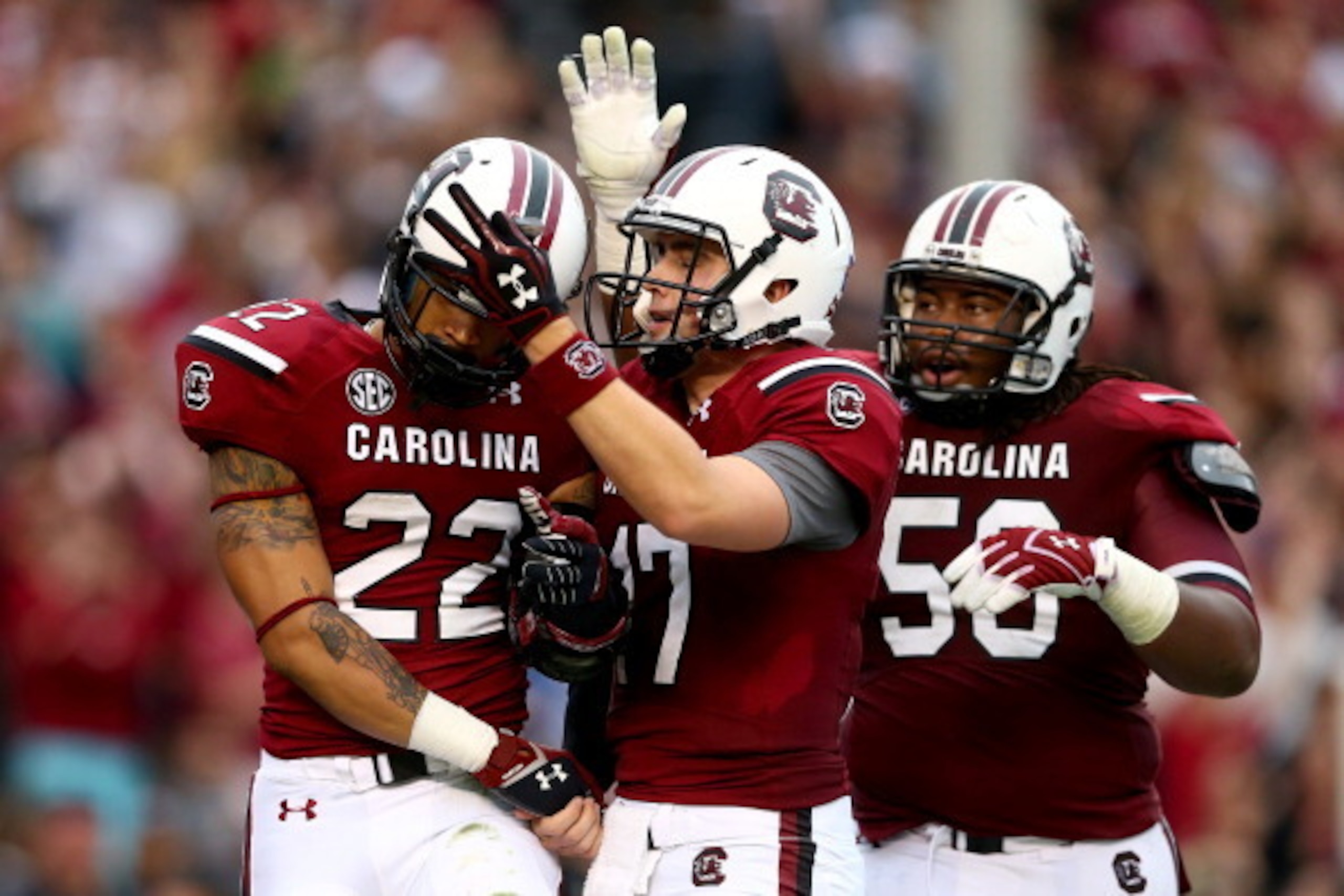 COLUMBIA, SC - NOVEMBER 23: Dylan Thompson #17 of the South Carolina Gamecocks celebrates a touchdown to teammates Brandon Wilds #22 and A.J. Cann #50 during their game against the Coastal Carolina Chanticleers at Williams-Brice Stadium on November 23, 2 COLUMBIA, SC - NOVEMBER 23: Dylan Thompson #17 of the South Carolina Gamecocks celebrates a touchdown to teammates Brandon Wilds #22 and A.J. Cann #50 during their game against the Coastal Carolina Chanticleers at Williams-Brice Stadium on November 23, 2