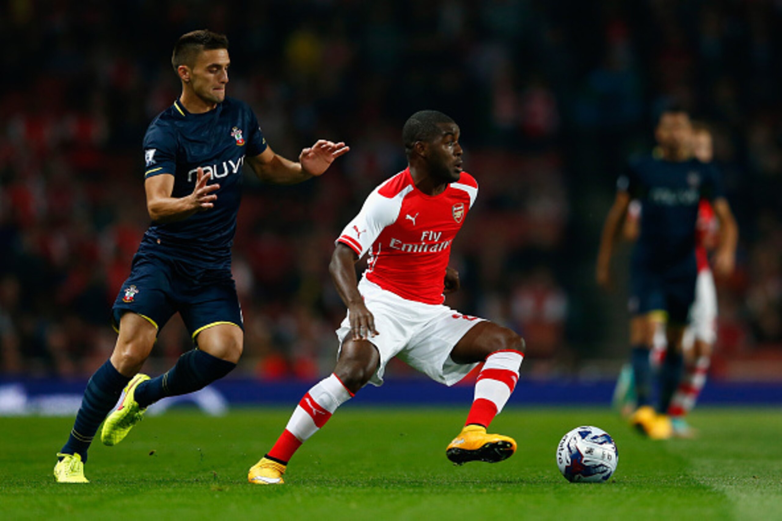 LONDON, ENGLAND - SEPTEMBER 23:  Joel Campbell of Arsenal battles with Dusan Tadic of Southampton during the Capital One Cup Third Round match between Arsenal and Southampton at the Emirates Stadium on September 23, 2014 in London, England.  (Photo by Jul