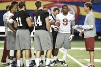 Dec 5, 2014; Atlanta, GA, USA;  Alabama Crimson Tide wide receiver Amari Cooper (9) (with ball) listens as offensive coordinator Lane Kiffin, right, works with quarterbacks and receivers during practice at the Georgia Dome. Alabama plays the Missouri Tige