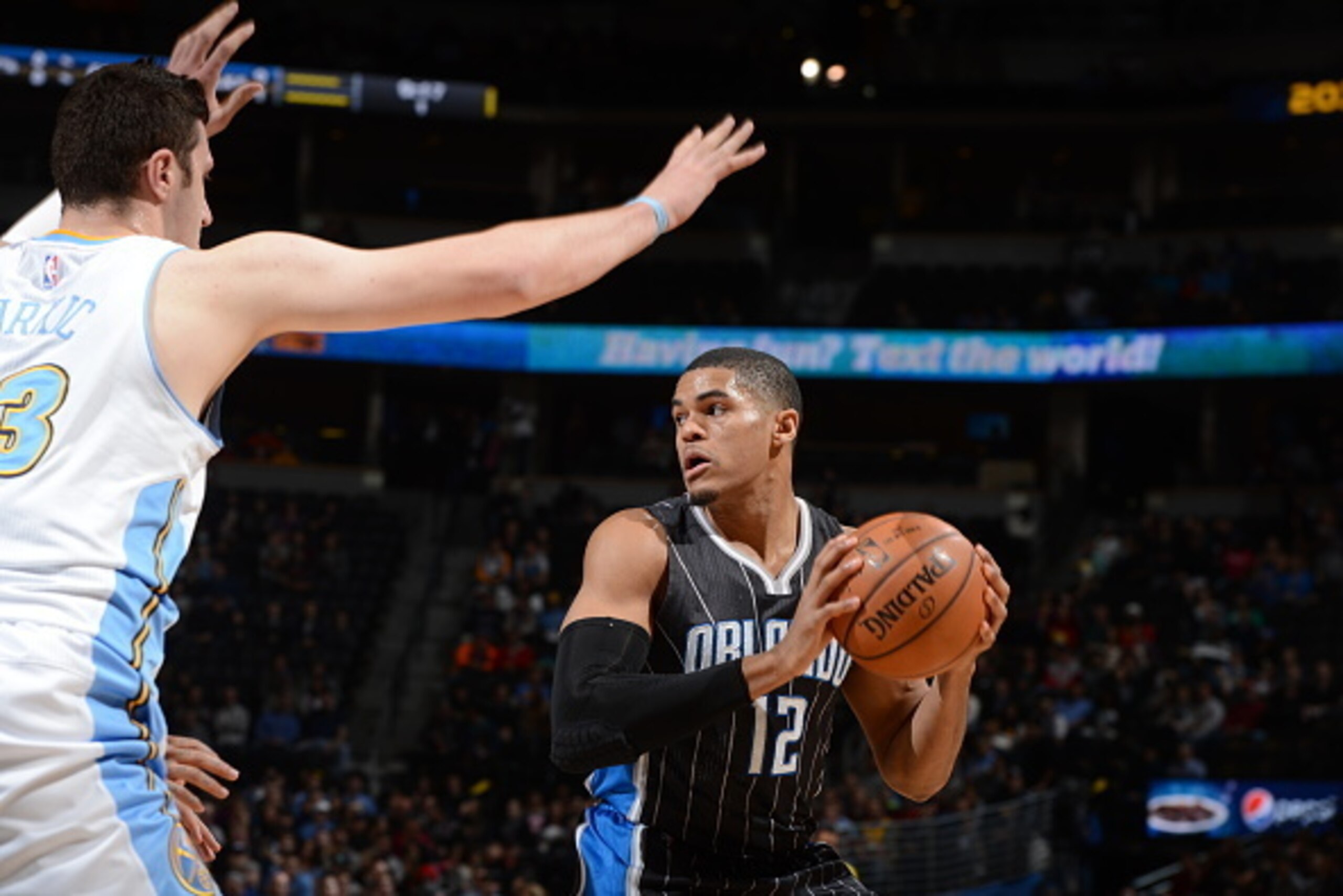 DENVER, CO - JANUARY 7:  Tobias Harris #12 of the Orlando Magic handles the ball against Jusuf Nurkic #23 of the Denver Nuggets on January 7, 2015 at the Pepsi Center in Denver, Colorado. NOTE TO USER: User expressly acknowledges and agrees that, by downl