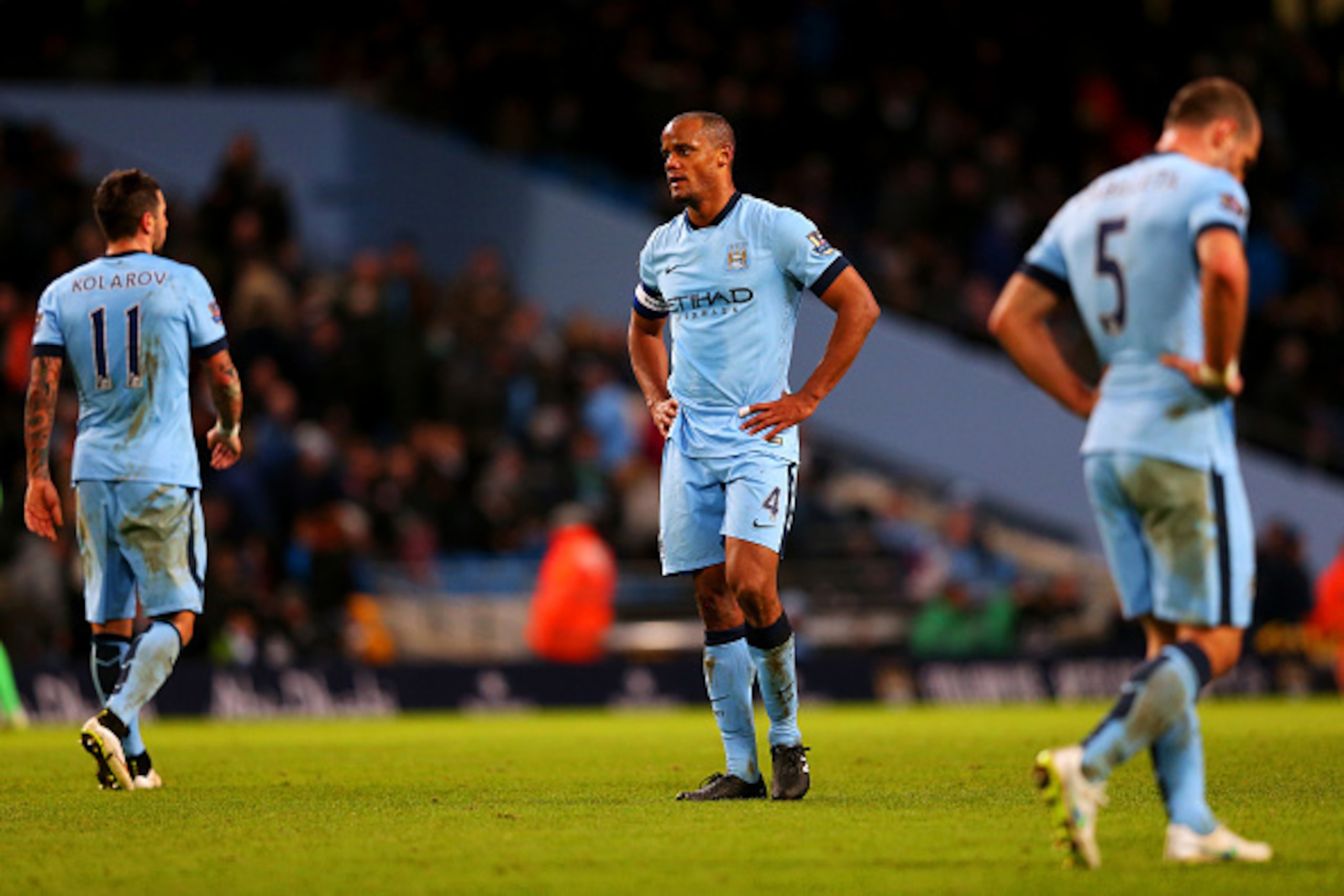 MANCHESTER, ENGLAND - JANUARY 24:  Vincent Kompany (C), Aleksandar Kolarov (L) and Pablo Zabaleta of Manchester City show their dejection after conceding a goal during the FA Cup Fourth Round match between Manchester City and Middlesbrough at Etihad Stadi