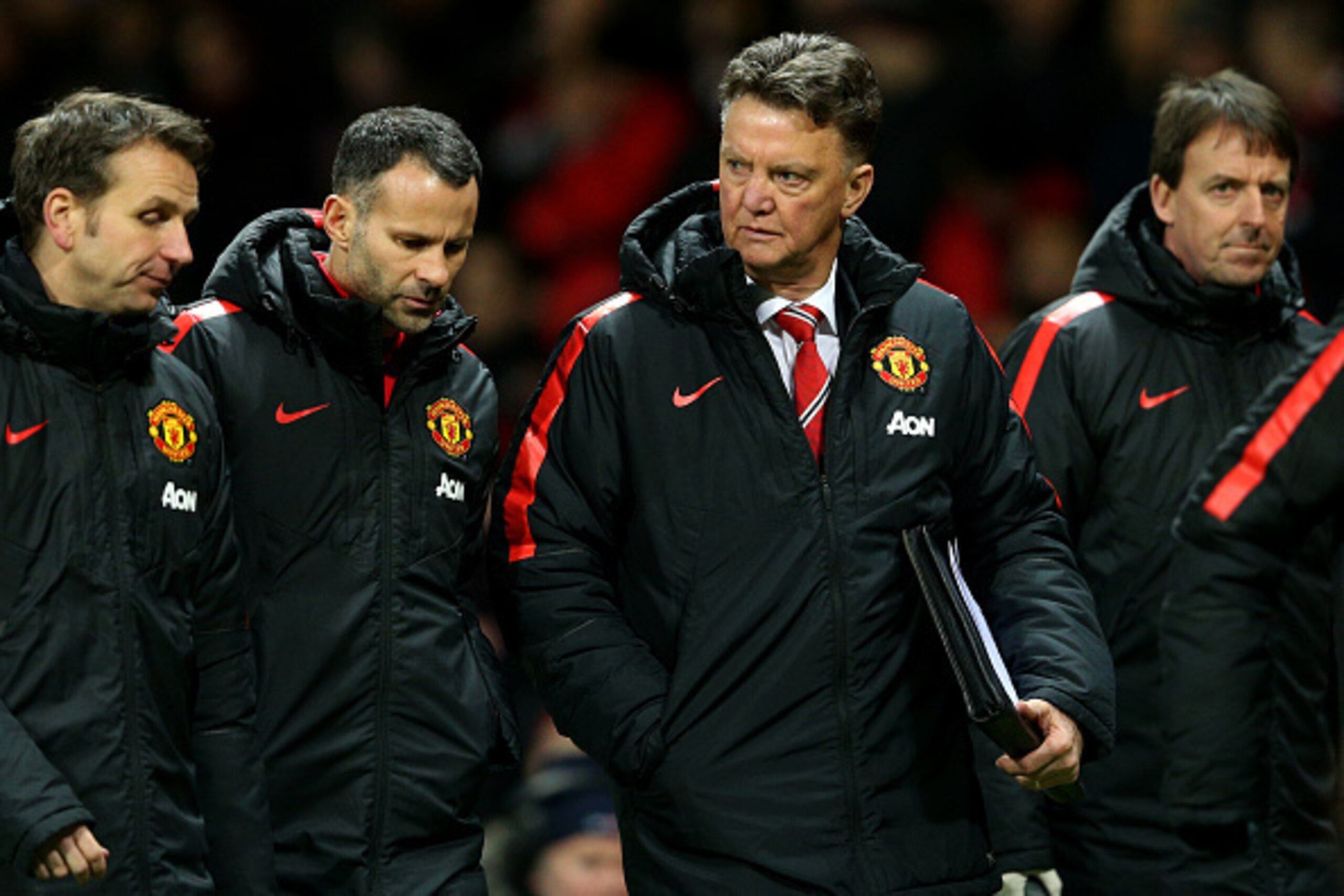 MANCHESTER, ENGLAND - JANUARY 11: Louis van Gaal, manager of Manchester United, assistant manager Ryan Giggs and assistant coach Albert Stuivenberg (L) speak as they leave the pitch at half-time during the Barclays Premier League match between Manchester MANCHESTER, ENGLAND - JANUARY 11: Louis van Gaal, manager of Manchester United, assistant manager Ryan Giggs and assistant coach Albert Stuivenberg (L) speak as they leave the pitch at half-time during the Barclays Premier League match between Manchester