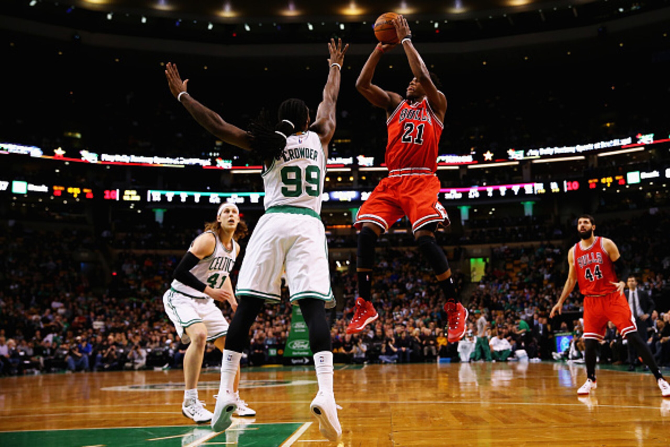 BOSTON, MA - JANUARY 16:  Jimmy Butler #21 of the Chicago Bulls takes a shot over Jae Crowder #99 of the Boston Celtics during the first quarter at TD Garden on January 16, 2015 in Boston, Massachusetts. NOTE TO USER: User expressly acknowledges and agree