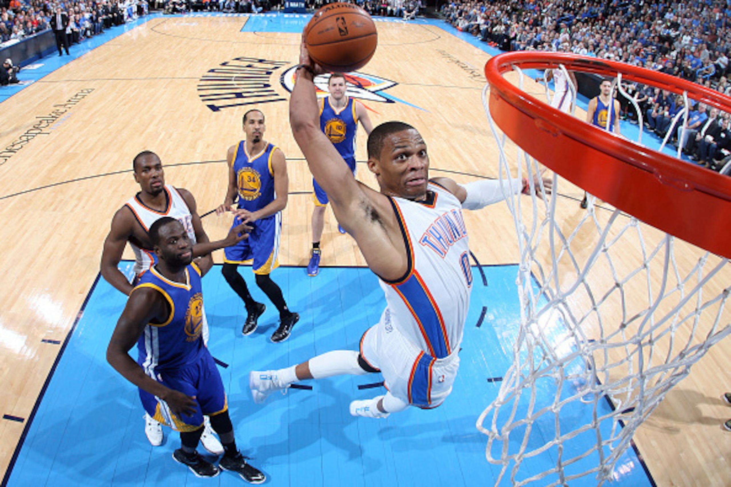OKLAHOMA CITY, OK- JANUARY 16: Russell Westbrook #0 of the Oklahoma City Thunder dunks against the Golden State Warriors on January 16, 2015 at Chesapeake Energy Arena in Oklahoma City, OK. NOTE TO USER: User expressly acknowledges and agrees that, by dow OKLAHOMA CITY, OK- JANUARY 16: Russell Westbrook #0 of the Oklahoma City Thunder dunks against the Golden State Warriors on January 16, 2015 at Chesapeake Energy Arena in Oklahoma City, OK. NOTE TO USER: User expressly acknowledges and agrees that, by dow