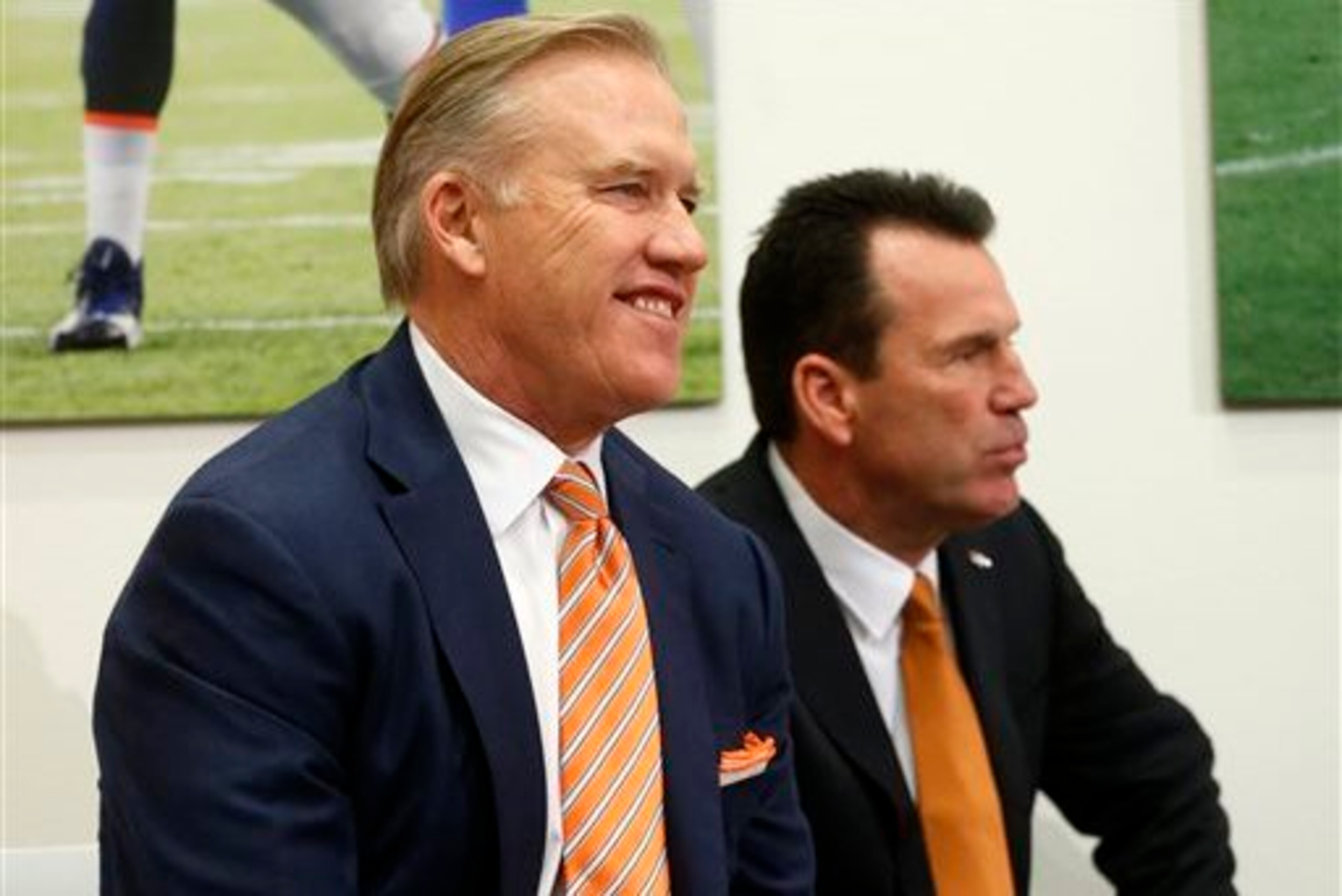 John Elway, with Gary Kubiak in the background where he belongs. John Elway, with Gary Kubiak in the background where he belongs.
