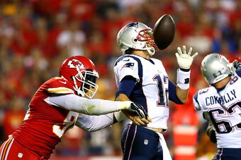 KANSAS CITY, MO - SEPTEMBER 29:  Tamba Hali #91 of the Kansas City Chiefs knocks the ball loose from Tom Brady #12 of the New England Patriots for a fumble during the third quarter at Arrowhead Stadium on September 29, 2014 in Kansas City, Missouri.  (Pho