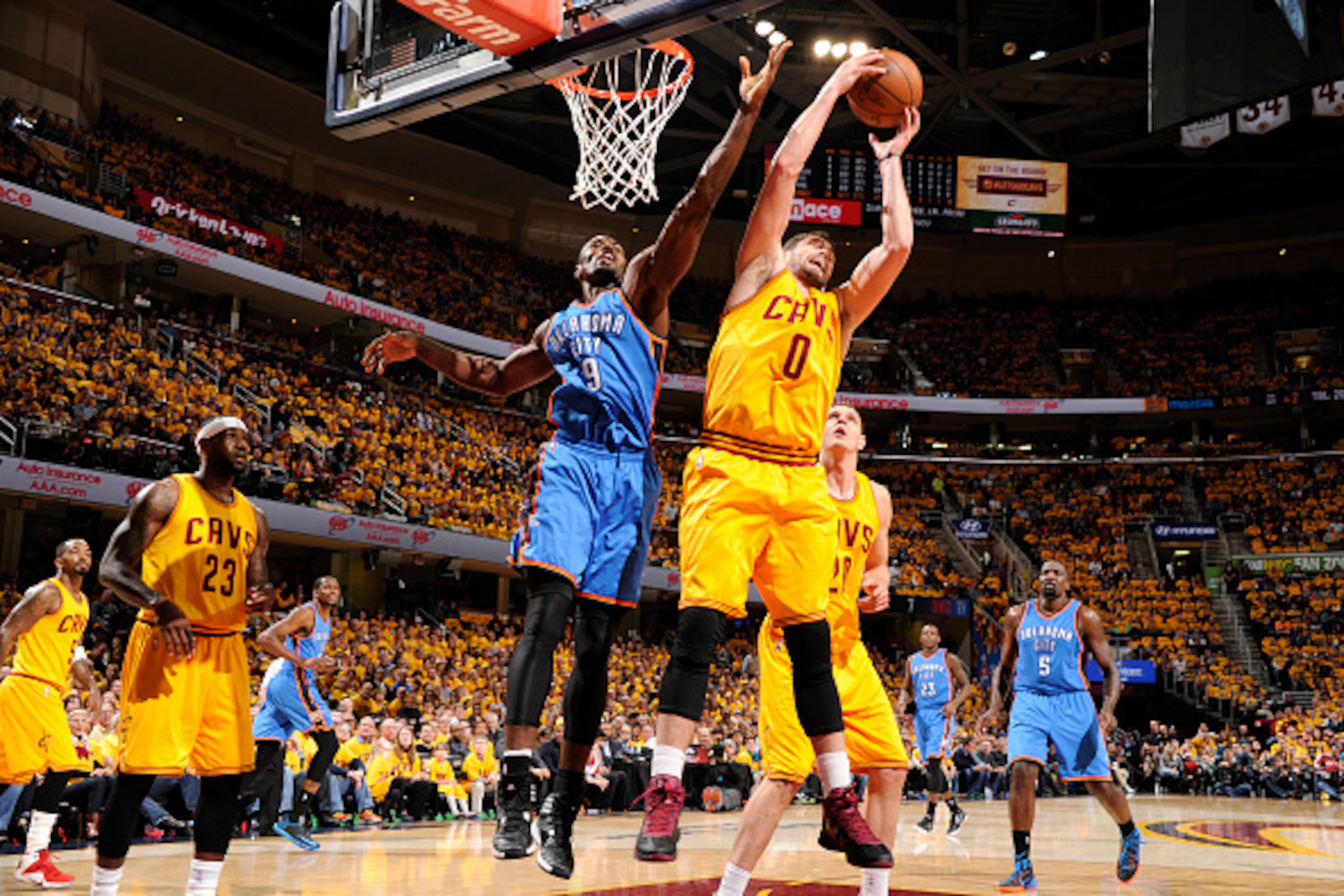 CLEVELAND, OH - JANUARY 25:  Kevin Love #0 of the Cleveland Cavaliers grabs the rebound against Serge Ibaka #9 of the Oklahoma City Thunder during the game on January 25, 2015 at Quicken Loans Arena in Cleveland, Ohio. NOTE TO USER: User expressly acknowl