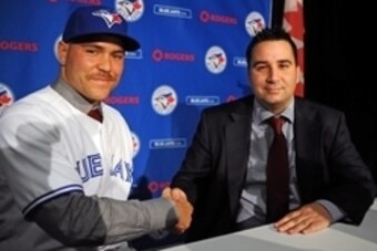 Nov 20, 2014; Toronto, Ontario, CAN;  Toronto Blue Jays catcher Russell Martin (left) shakes hands with general manager Alex Anthopoulos after Martin was introduced at a press conference at Rogers Centre. Mandatory Credit: Dan Hamilton-USA TODAY Sports