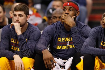 PHOENIX, AZ - JANUARY 13:  Joe Harris #12 and LeBron James #23 of the Cleveland Cavaliers react on the bench during the second half of the NBA game against the Phoenix Suns at US Airways Center on January 13, 2015 in Phoenix, Arizona. The Suns defeated th