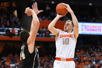 SYRACUSE, NY - JANUARY 13:  Trevor Cooney #10 of the Syracuse Orange shoots the ball against the defense of Konstantinos Mitoglou #44 of the Wake Forest Demon Deacons during the second half at the Carrier Dome on January 13, 2015 in Syracuse, New York.  S