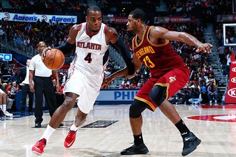ATLANTA, GA - DECEMBER 30:  Paul Millsap #4 of the Atlanta Hawks drives against Tristan Thompson #13 of the Cleveland Cavaliers at Philips Arena on December 30, 2014 in Atlanta, Georgia.  NOTE TO USER: User expressly acknowledges and agrees that, by downl