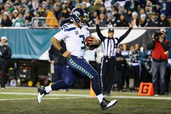 PHILADELPHIA, PA - DECEMBER 07:  Quarterback  Russell Wilson #3 of the Seattle Seahawks runs 26 yards for a touchdown in the second quarter of the game against the Philadelphia Eagles at Lincoln Financial Field on December 7, 2014 in Philadelphia, Pennsyl