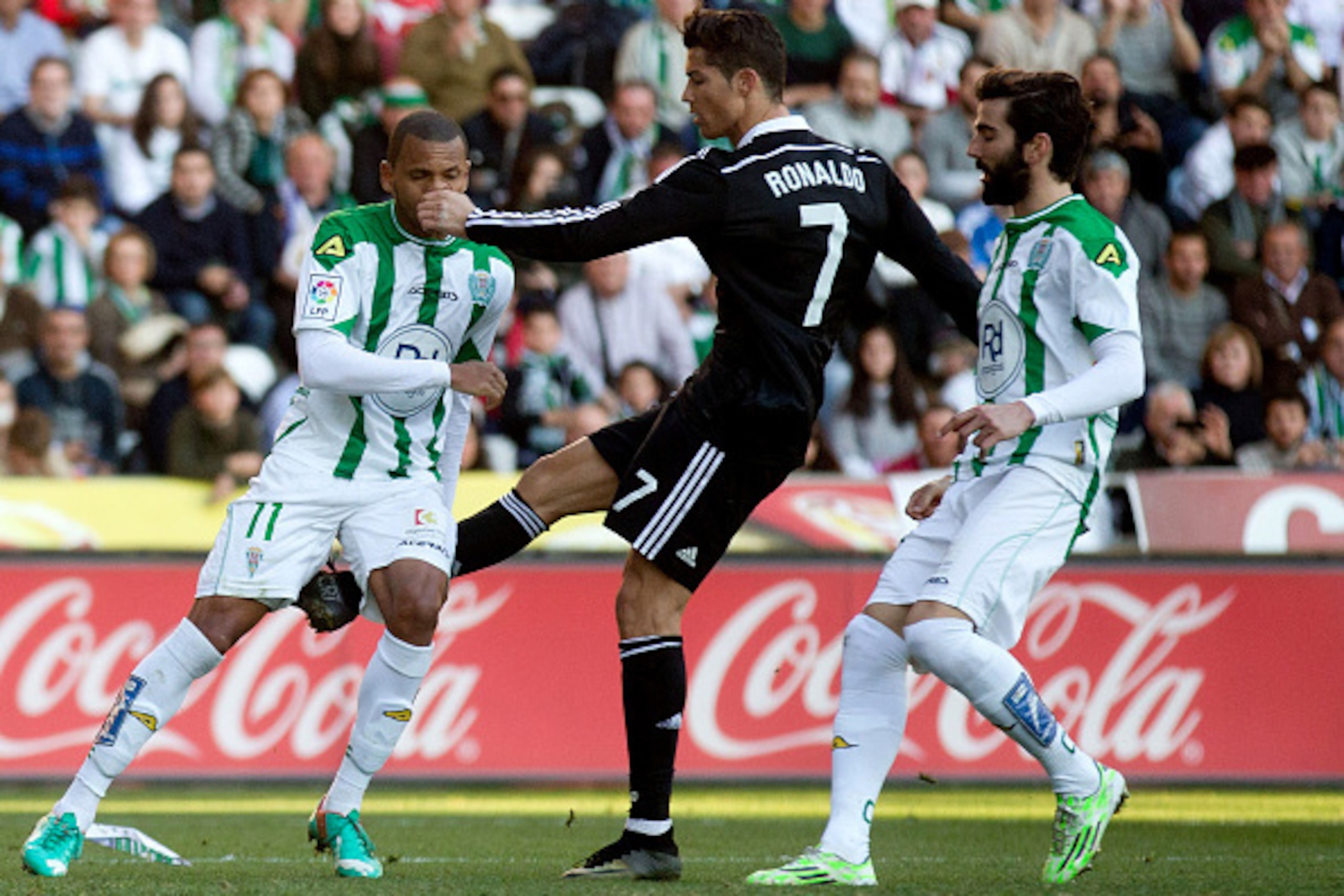 CORDOBA, SPAIN - JANUARY 24: Cristiano Ronaldo (2ndL) of Real Madrid CF kicks Edimar Fraga (L) of Cordoba CF, that motivated his expulsion form the pitch after being reprimanded with a red card by referee Hernandez Hernandez during the La Liga match betwe