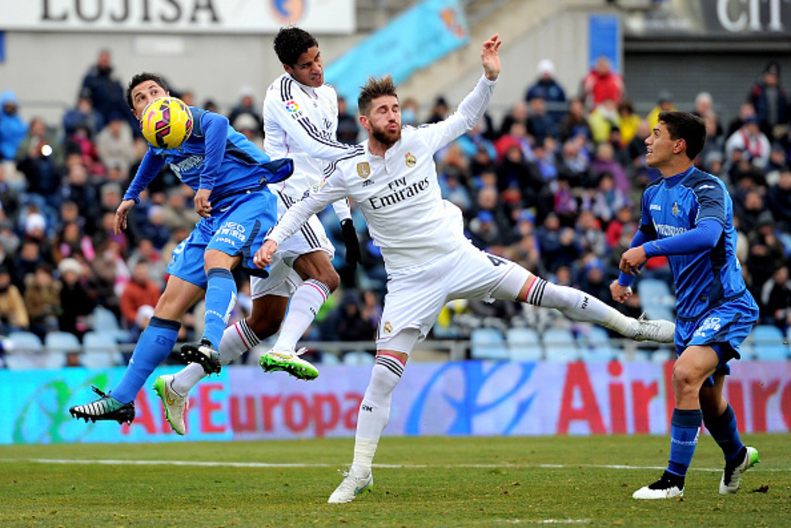 GETAFE, SPAIN - JANUARY 18: Sergio Ramos and Raphael Varane of of Real Madrid battle for the ball against Roberto Lago of Getafe CF during the La Liga match between Getafe CF and Real Madrid CF at Coliseum Alfonso Perez stadium on January 18, 2015 in Geta