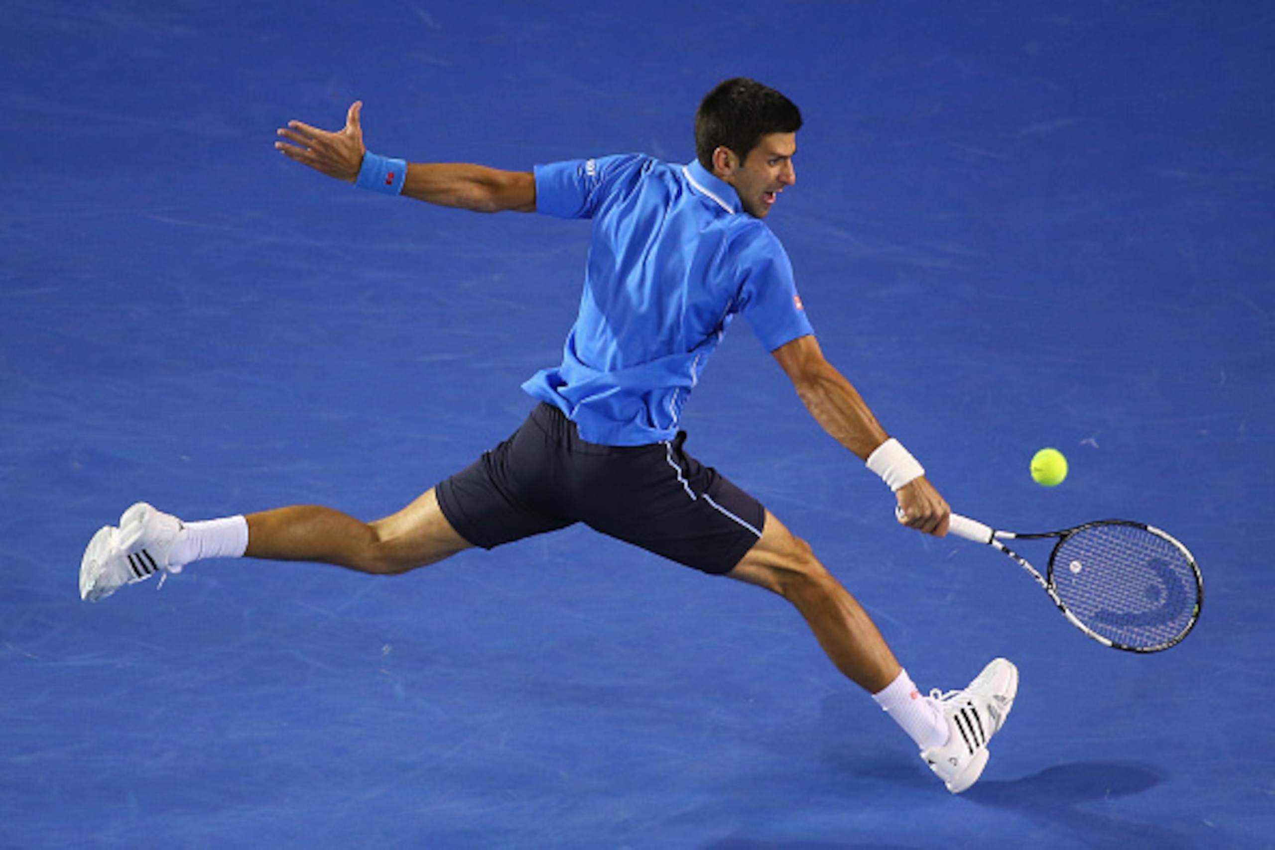 MELBOURNE, AUSTRALIA - JANUARY 26:  Novak Djokovic of Serbia plays a backhand in his fourth round match against Gilles Muller of Luxembourg during day eight of the 2015 Australian Open at Melbourne Park on January 26, 2015 in Melbourne, Australia  (Photo 