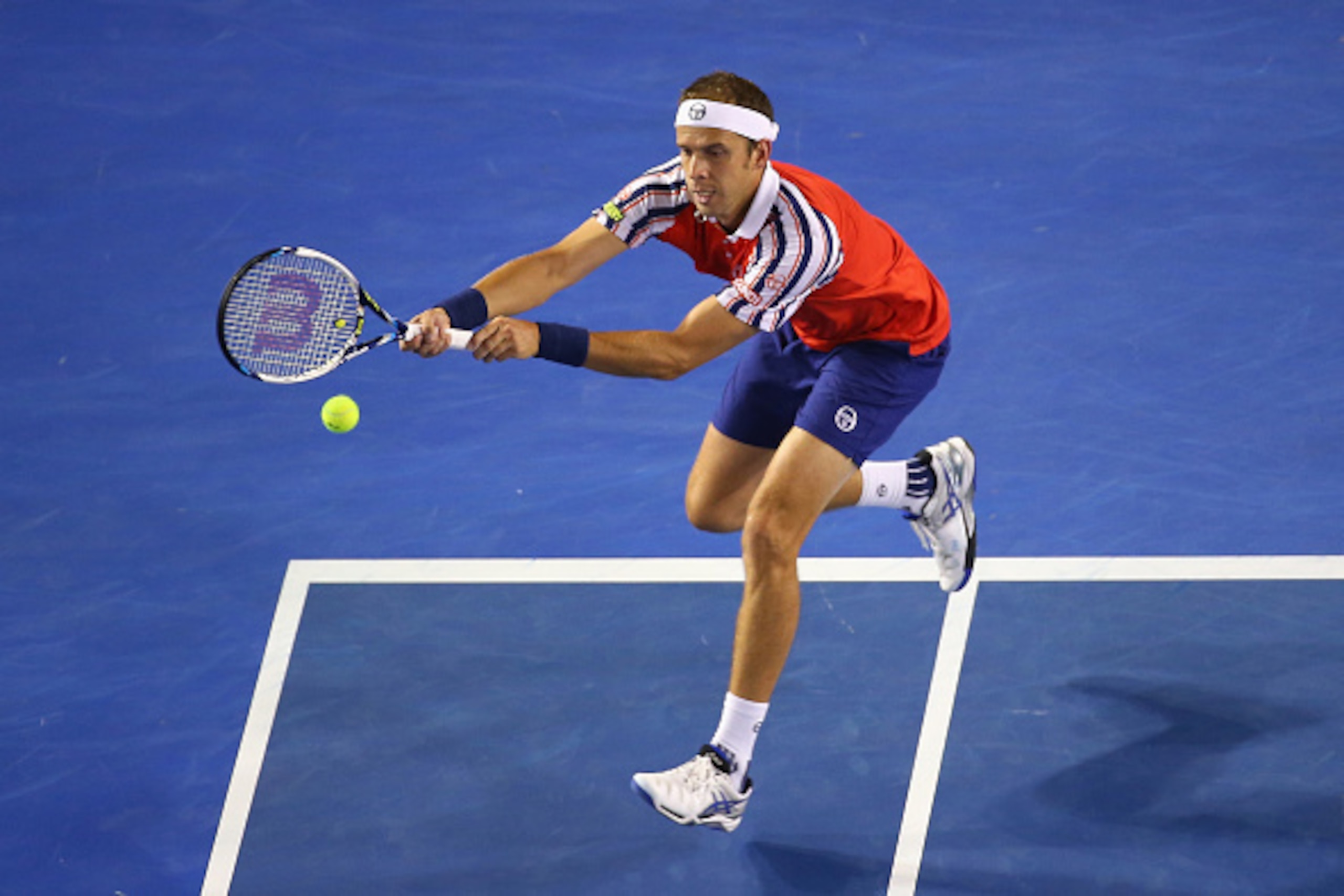 MELBOURNE, AUSTRALIA - JANUARY 26:  Gilles Muller of Luxembourg plays a backhand in his fourth round match against Novak Djokovic of Serbia during day eight of the 2015 Australian Open at Melbourne Park on January 26, 2015 in Melbourne, Australia  (Photo 