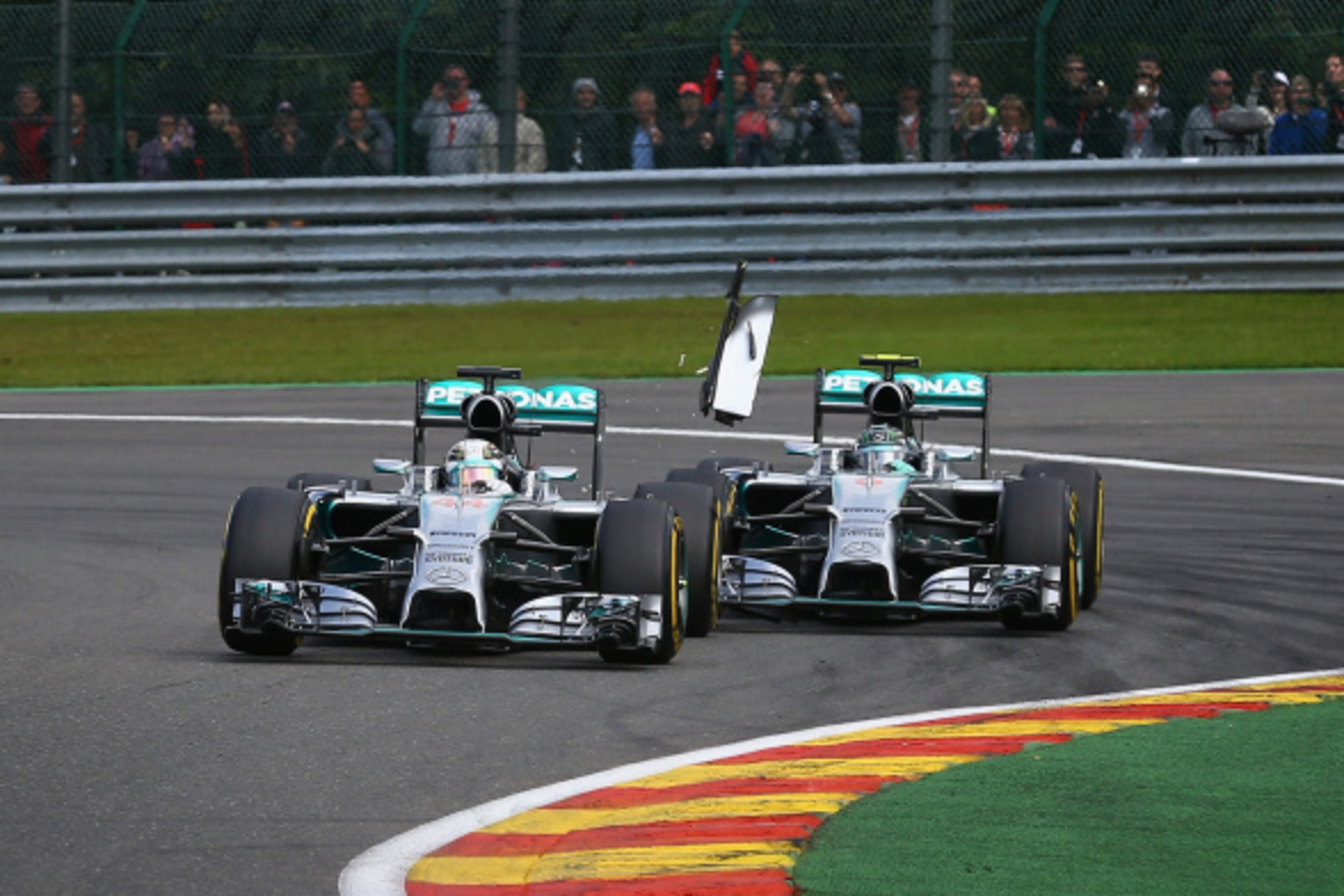 SPA, BELGIUM - AUGUST 24: Debris flies in the air as Nico Rosberg of Germany and Mercedes GP makes contact with Lewis Hamilton of Great Britain and Mercedes GP during the Belgian Grand Prix at Circuit de Spa-Francorchamps on August 24, 2014 in Spa, Belgi SPA, BELGIUM - AUGUST 24: Debris flies in the air as Nico Rosberg of Germany and Mercedes GP makes contact with Lewis Hamilton of Great Britain and Mercedes GP during the Belgian Grand Prix at Circuit de Spa-Francorchamps on August 24, 2014 in Spa, Belgi