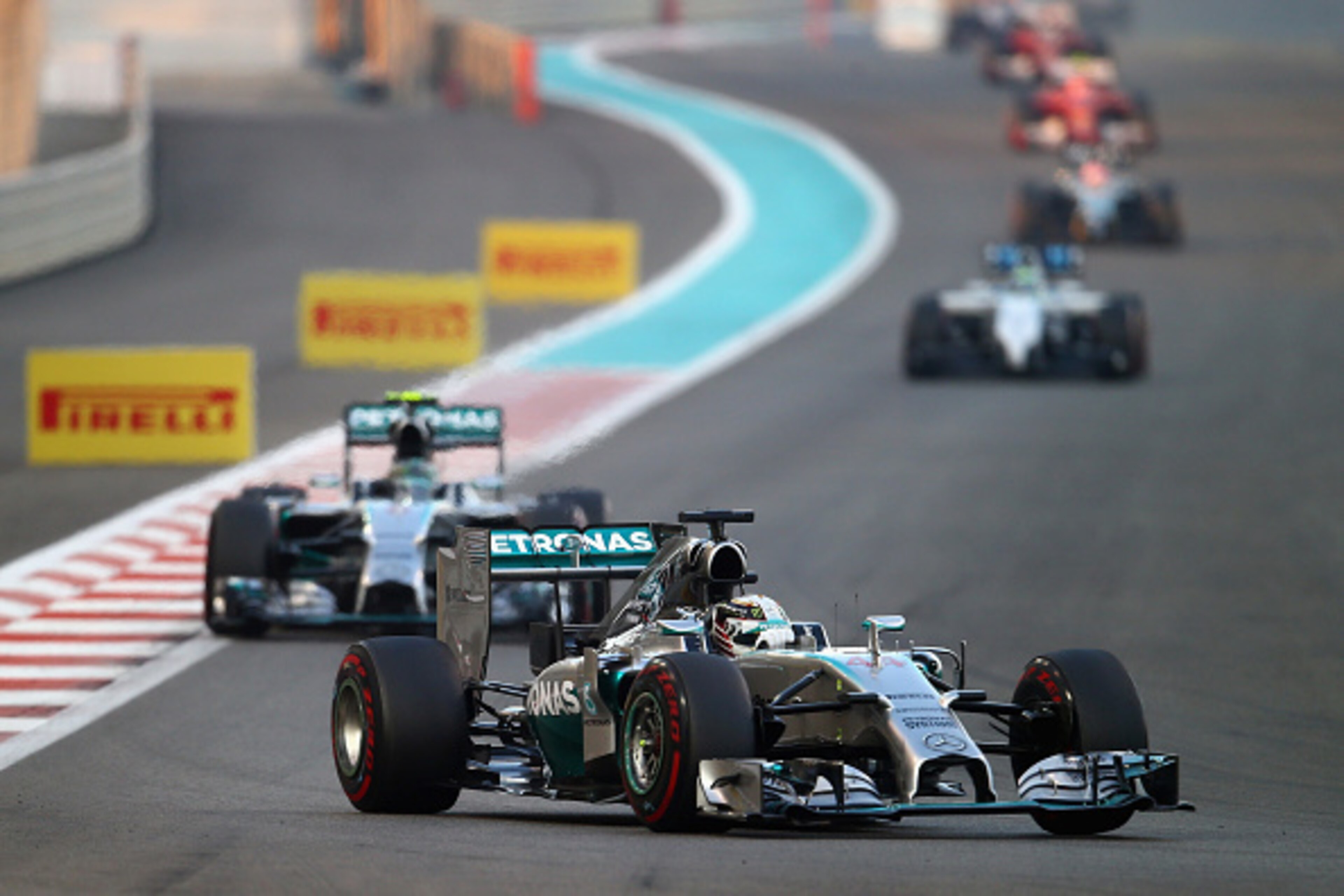 ABU DHABI, UNITED ARAB EMIRATES - NOVEMBER 23: Lewis Hamilton of Great Britain and Mercedes GP leads the field on the opening lap of the Abu Dhabi Formula One Grand Prix at Yas Marina Circuit on November 23, 2014 in Abu Dhabi, United Arab Emirates. (Pho ABU DHABI, UNITED ARAB EMIRATES - NOVEMBER 23: Lewis Hamilton of Great Britain and Mercedes GP leads the field on the opening lap of the Abu Dhabi Formula One Grand Prix at Yas Marina Circuit on November 23, 2014 in Abu Dhabi, United Arab Emirates. (Pho