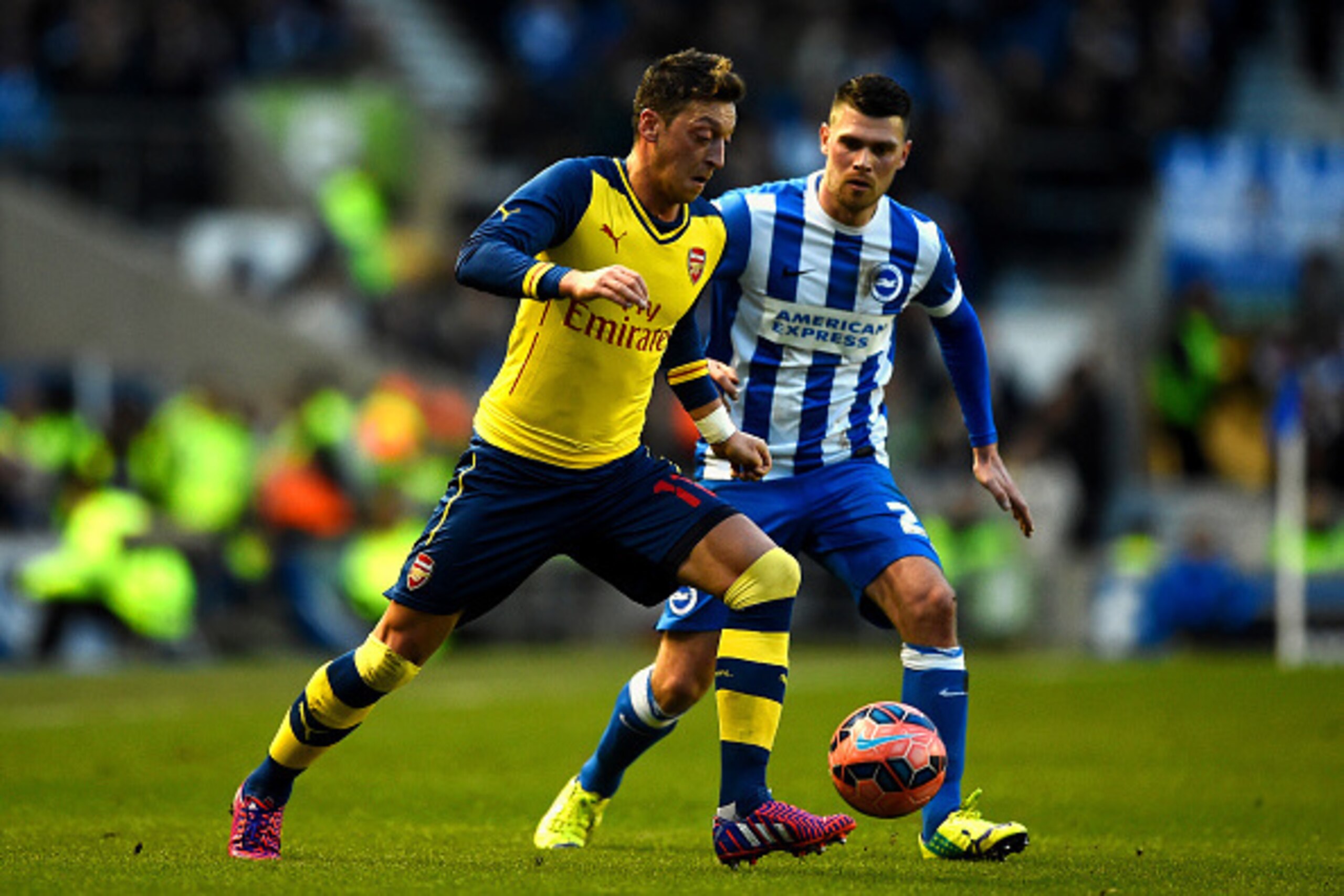 BRIGHTON, ENGLAND - JANUARY 25:  Mesut Oezil of Arsenal battles for the ball with Danny Holla of Brighton during the FA Cup Fourth Round match between Brighton & Hove Albion and Arsenal at Amex Stadium on January 25, 2015 in Brighton, England.  (Photo by 